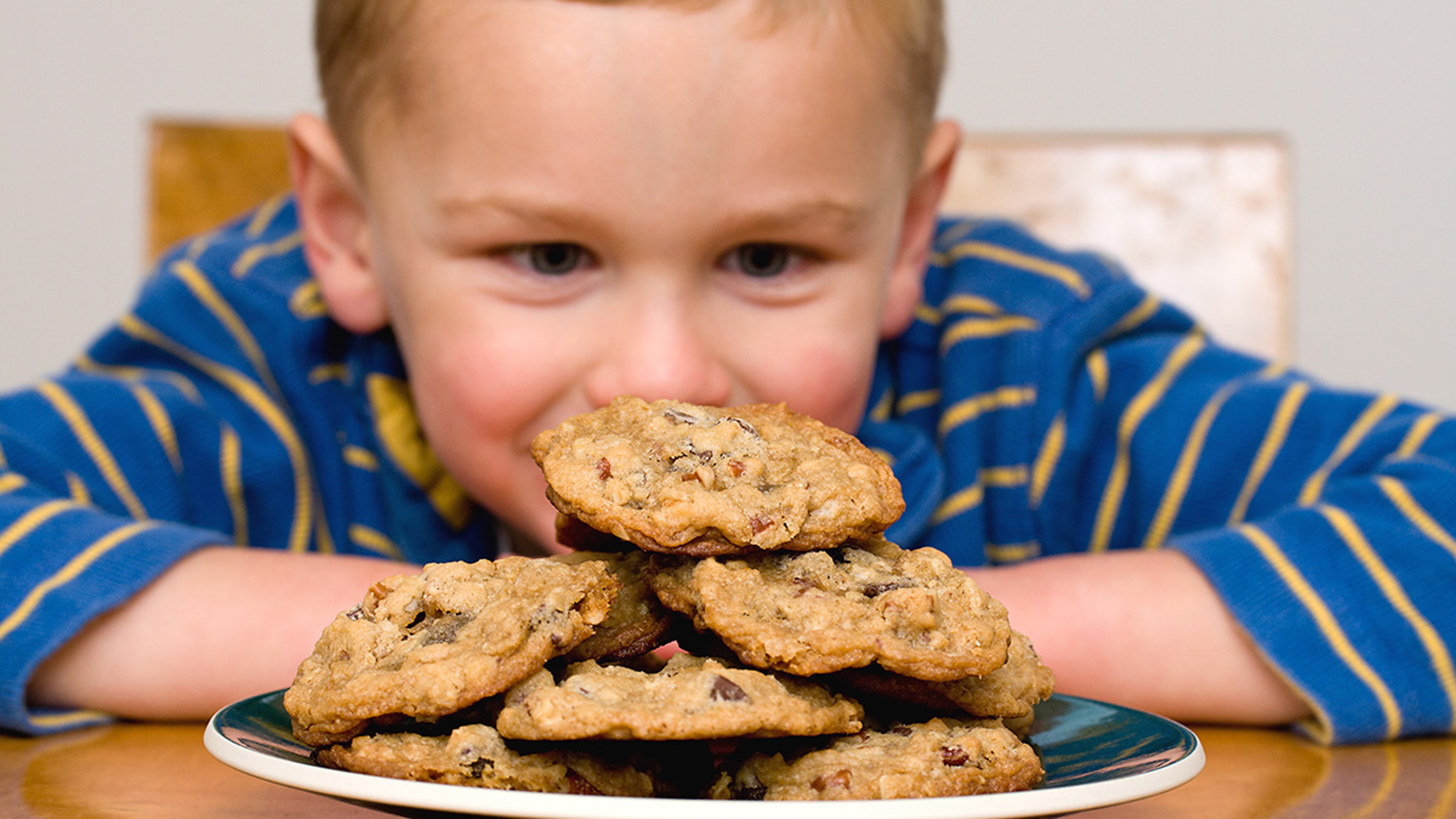 Article Cards Featured Image boy gazing at cookies on National Cookie Day