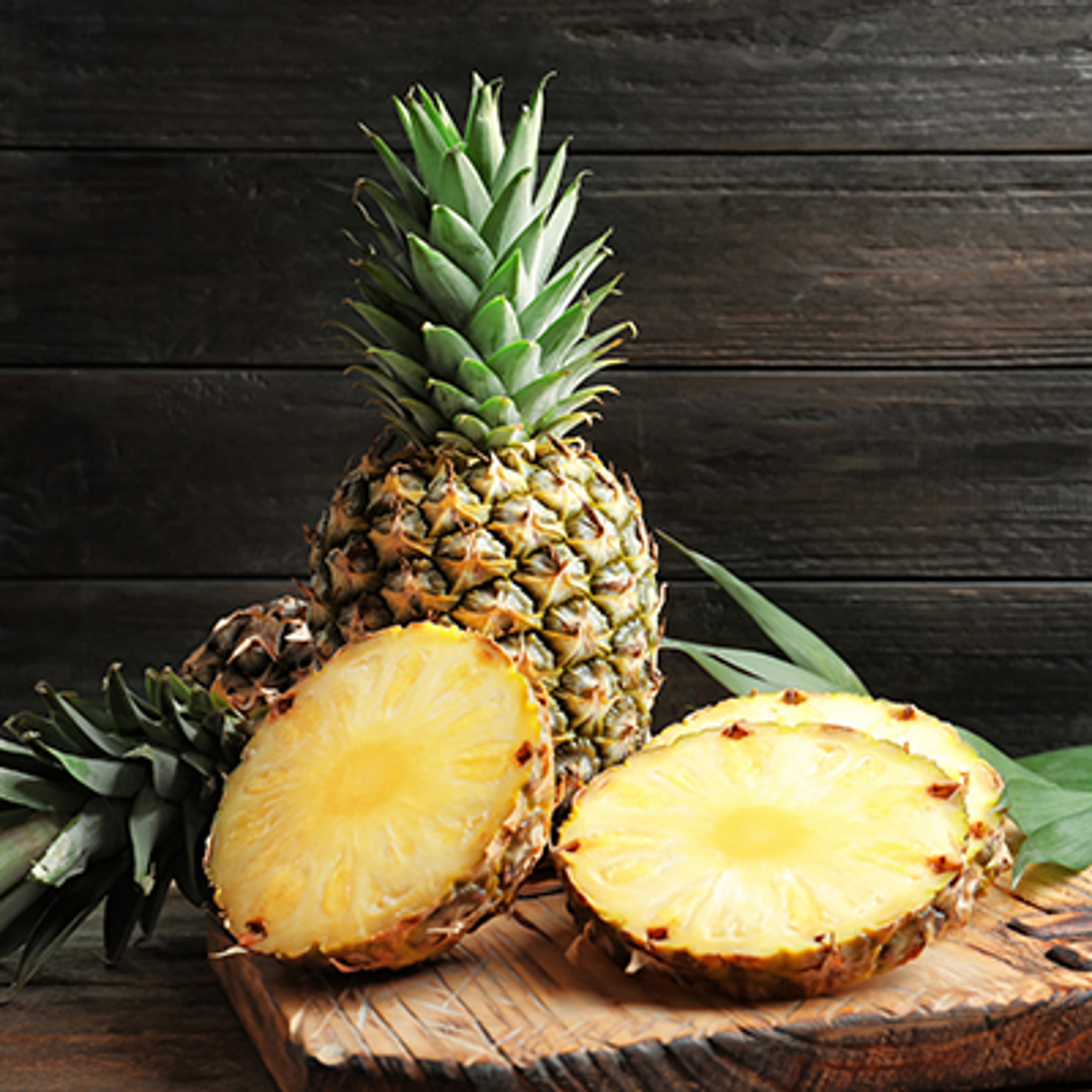 Fresh pineapple on wooden board