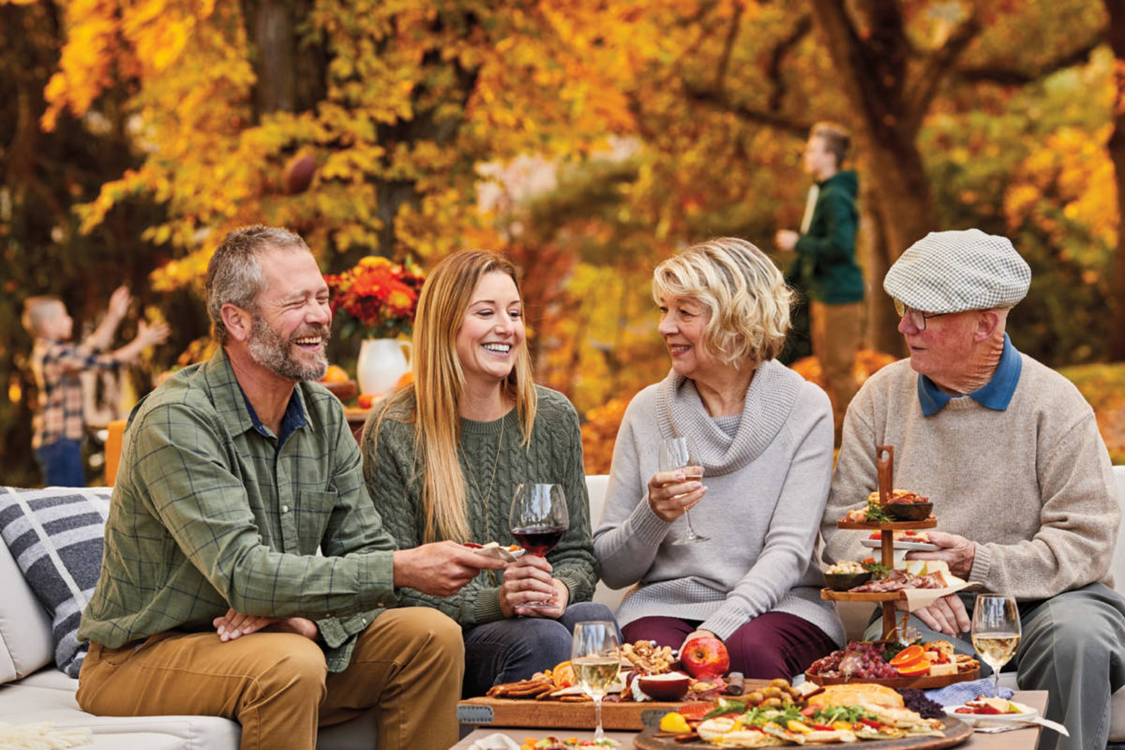 Group of adults celebrating an October birthday outside.