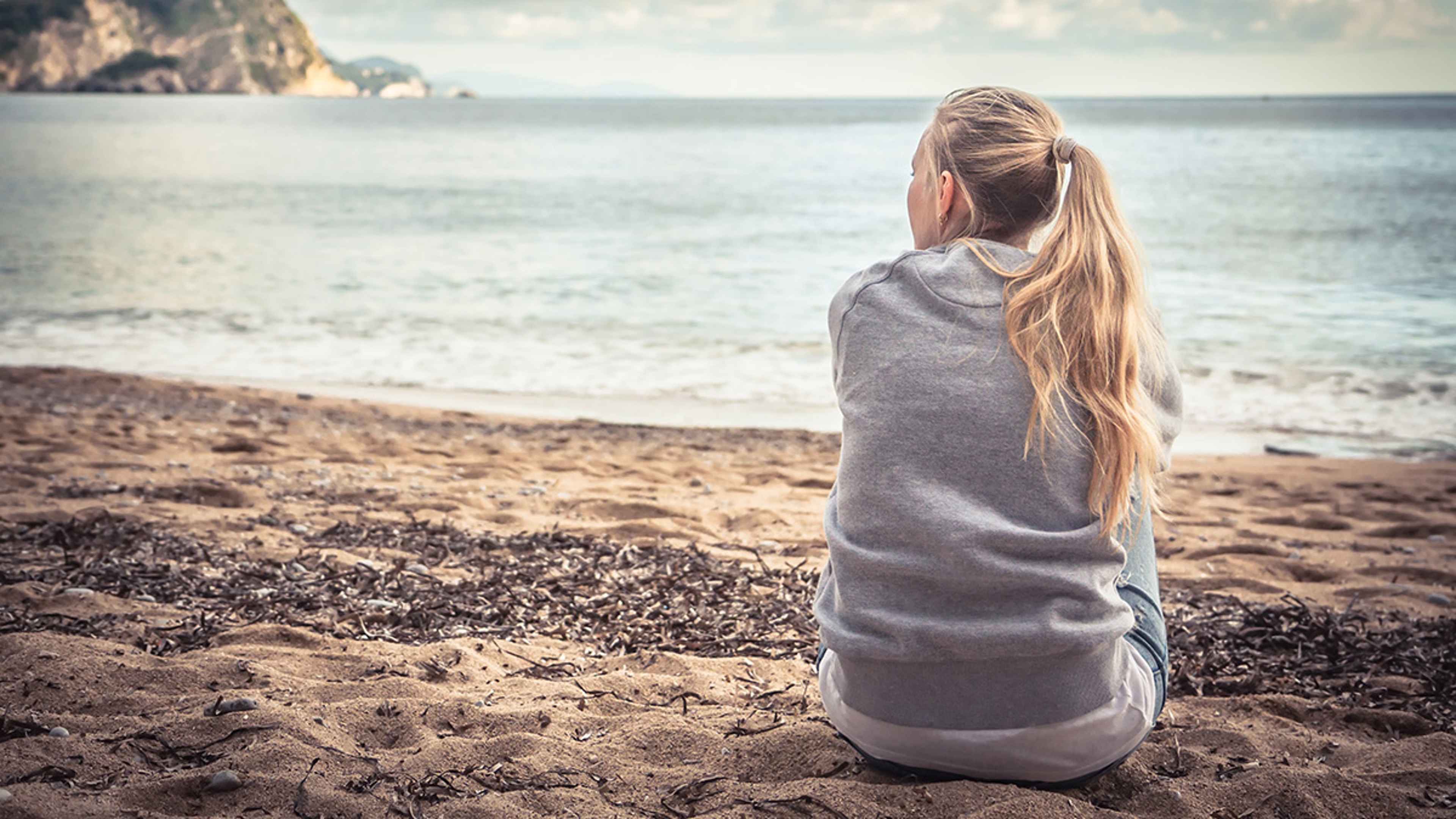 Article Cards Featured Image A young woman remembers a lost loved one while sitting alone at the seashore. An elderly man cries as he holds a photo of his deceased wife. Remembrance is a central part of life and a ritual that unites us, regardless of beliefs, religion, social status,