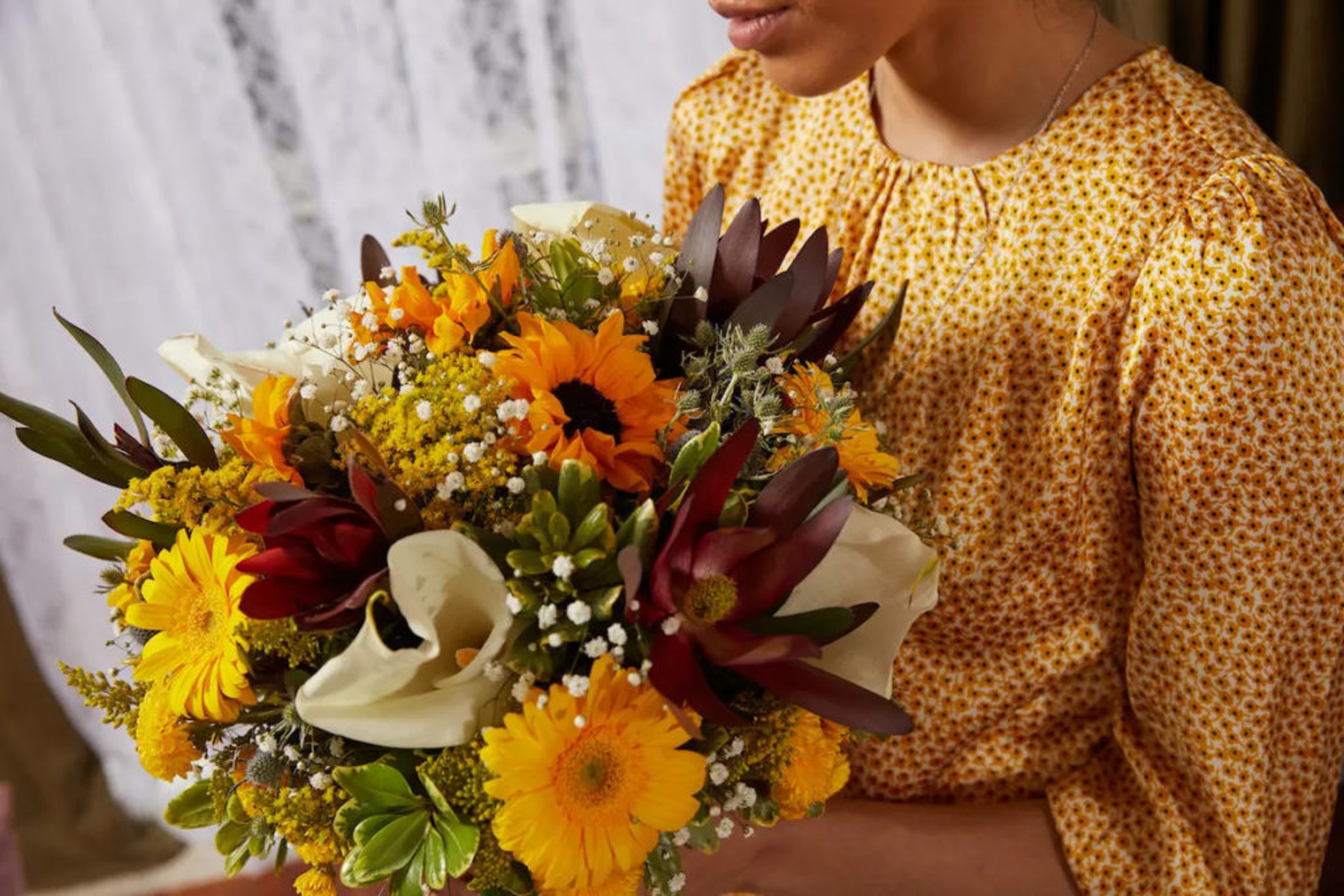 milestone birthdays th birthday woman holding bouquet of flowers