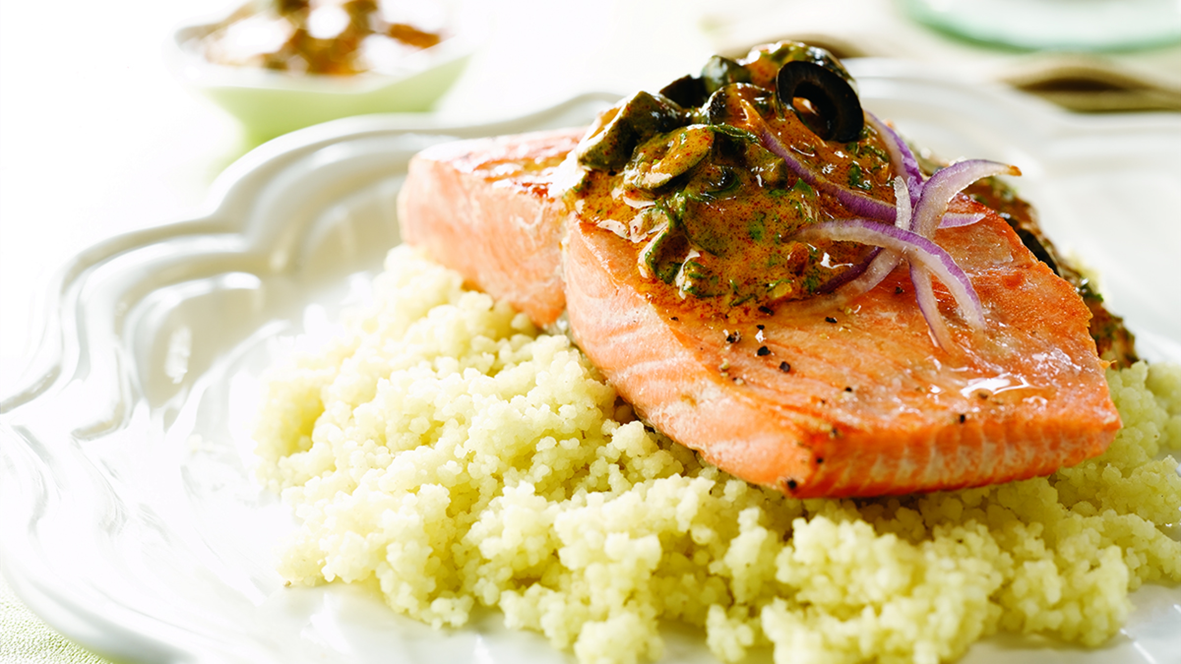 Seared salmon on a plate with couscous.