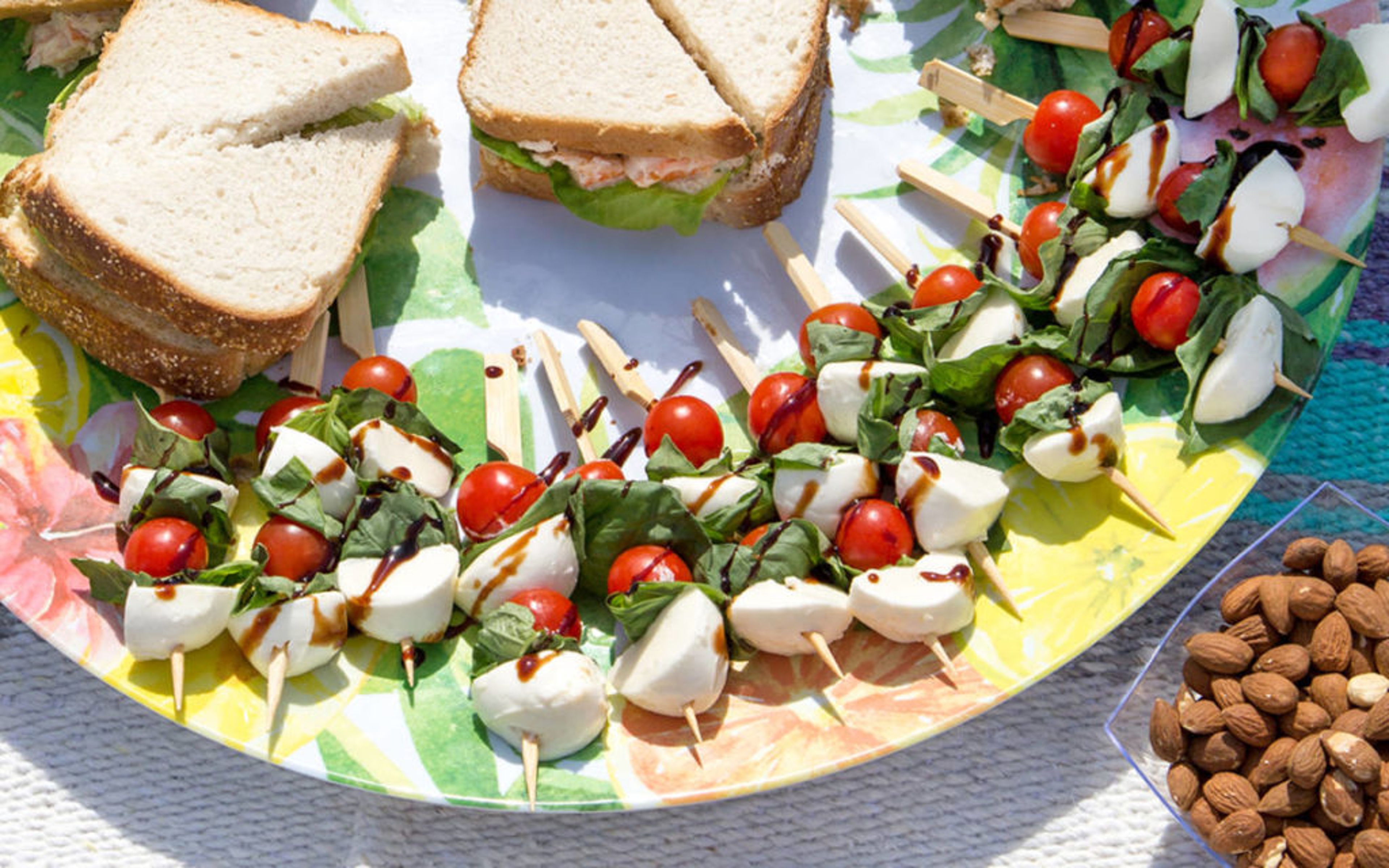 Caprese sandwich kebabs made from cheese, lettuce, cherry tomatoes and a balsamic vinaigrette