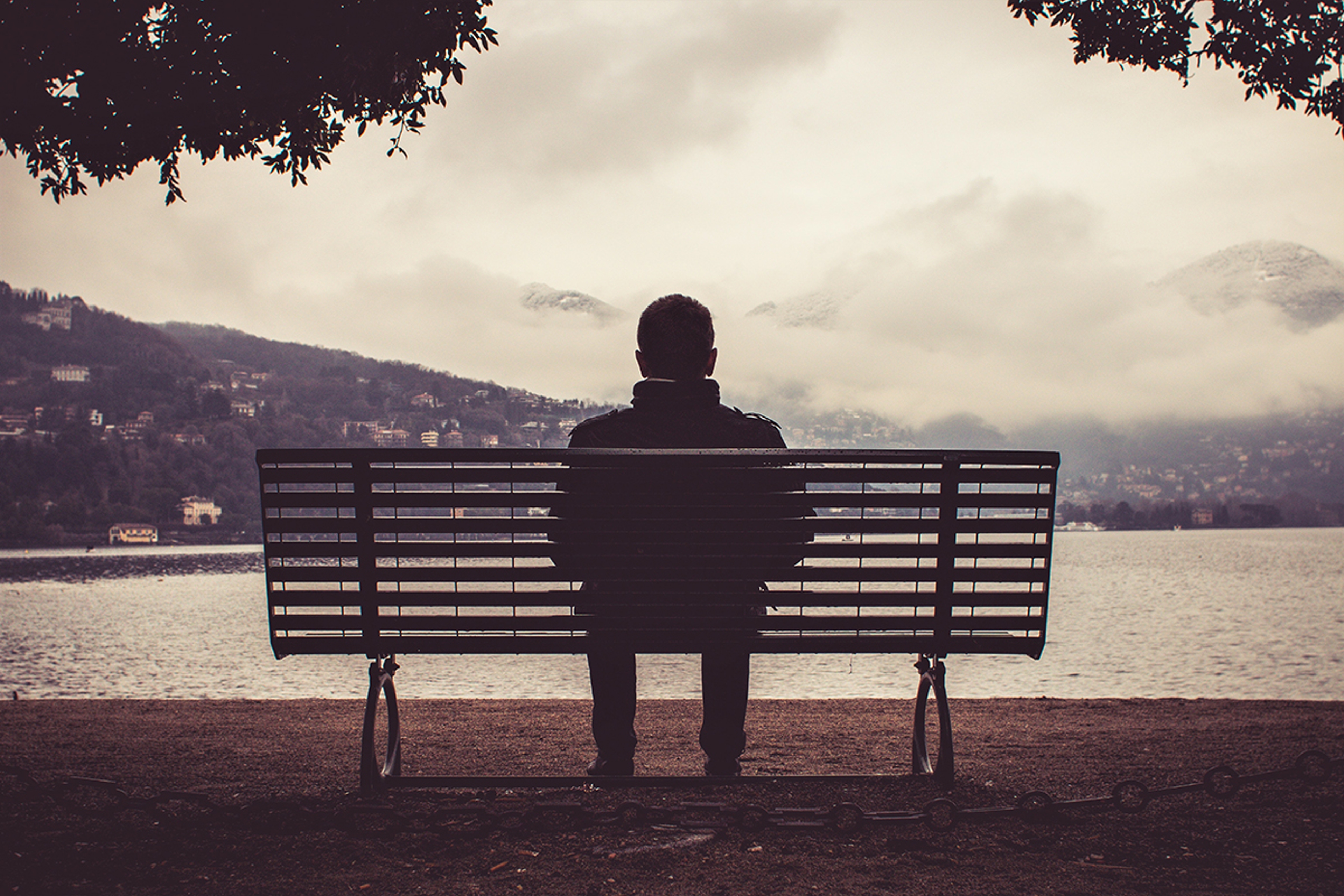 Article Cards Featured Image Como, Italy February , : A lonely man sitting on the ben