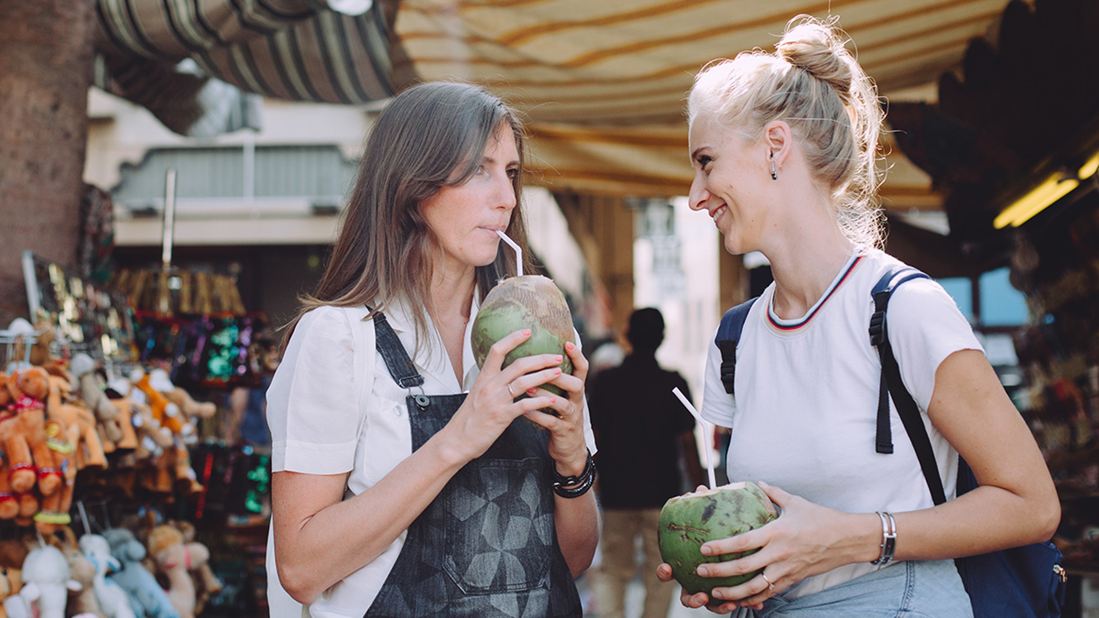 Article Cards Featured Image two women enjoying coconuts