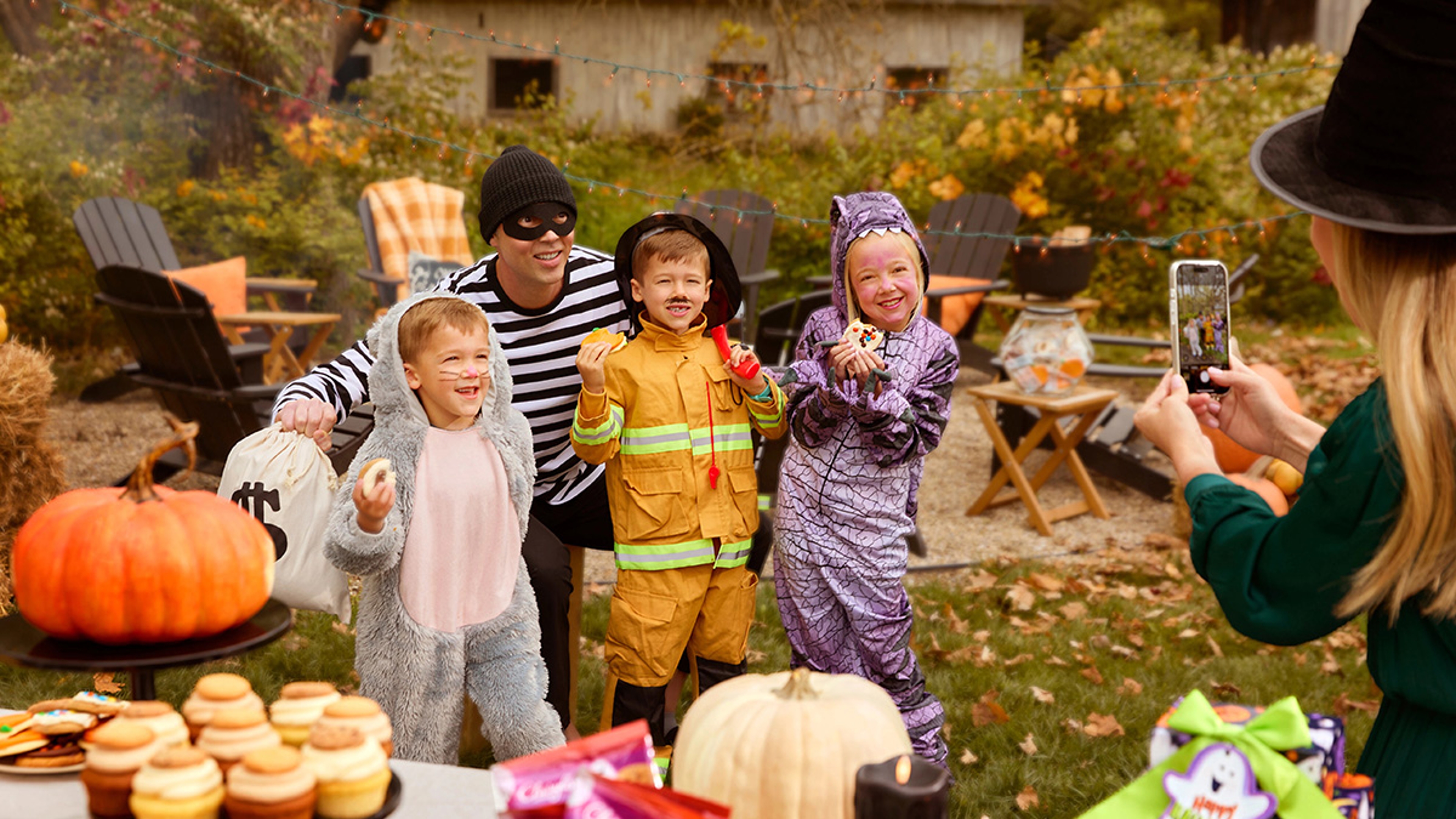 Group of kids dressed up for Halloween and posing for a picture.