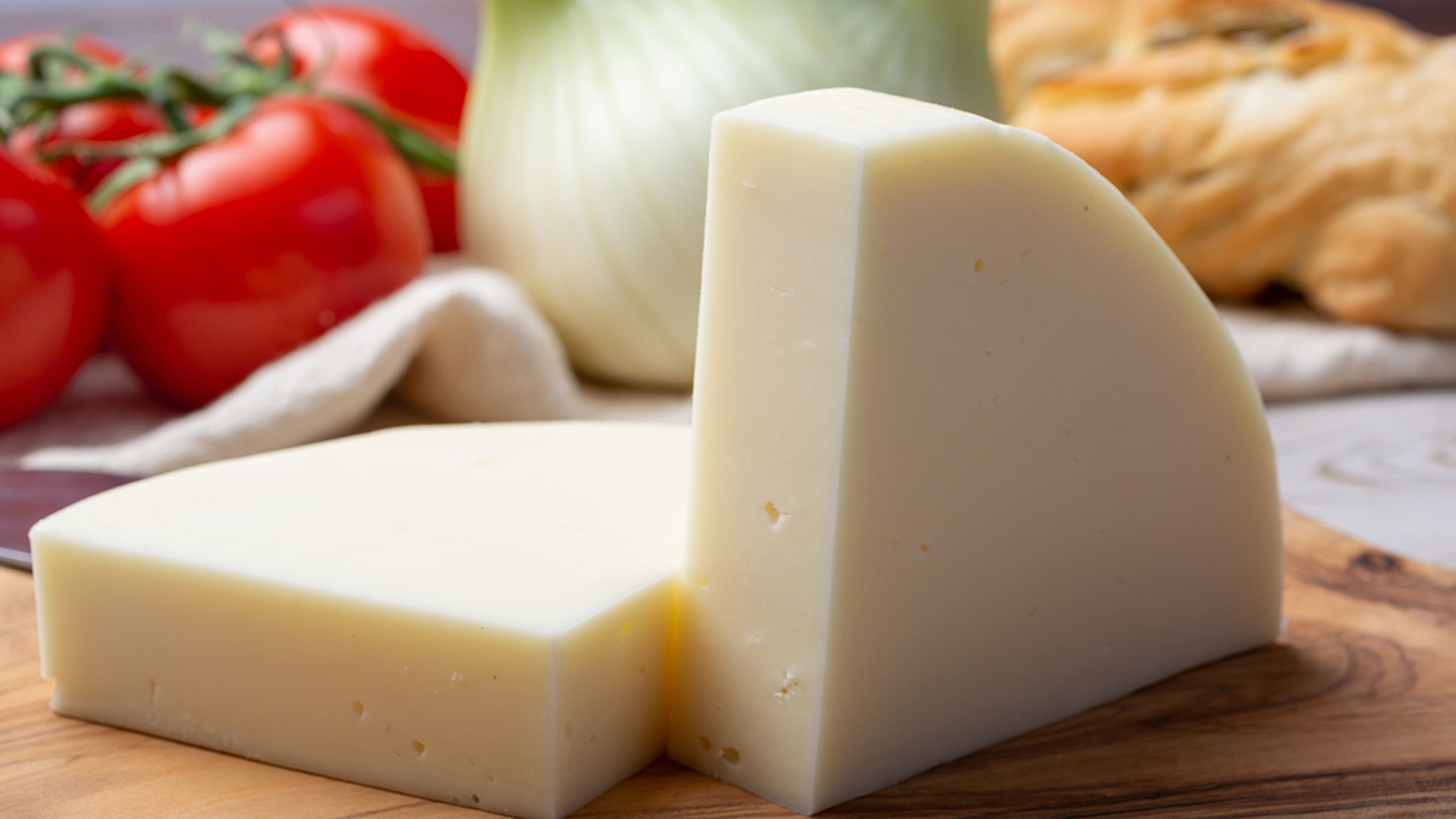 types of cheese Provolone cheese from Cremona served with olive bread and tomatoes