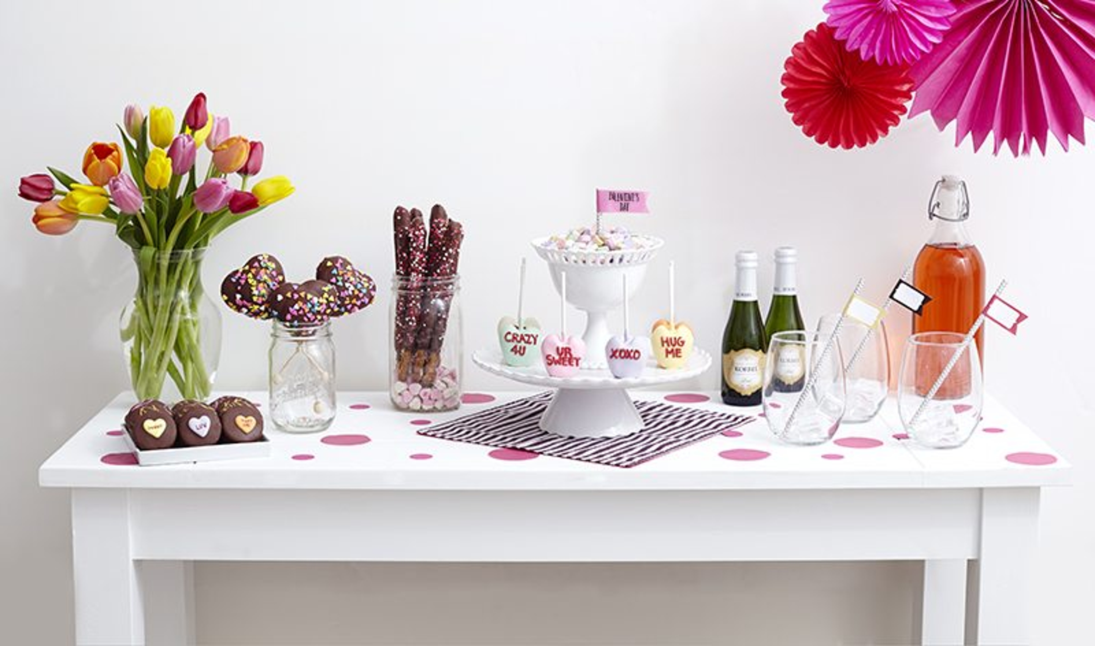 Table with flowers treats cake and drinks