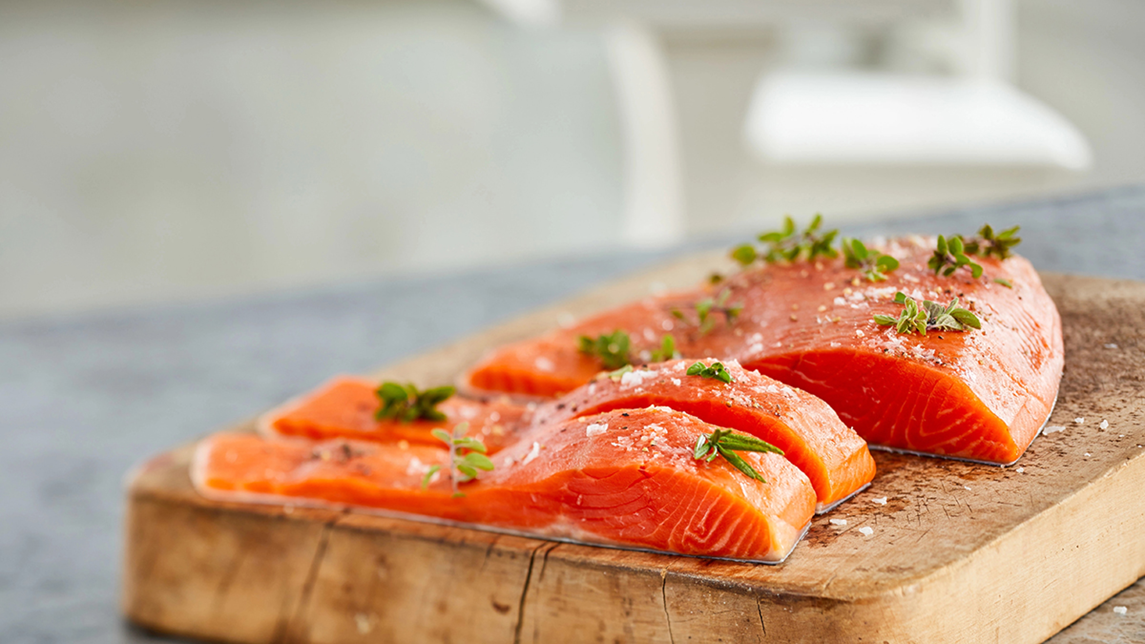 Questions about salmon with several salmon fillets on a board.