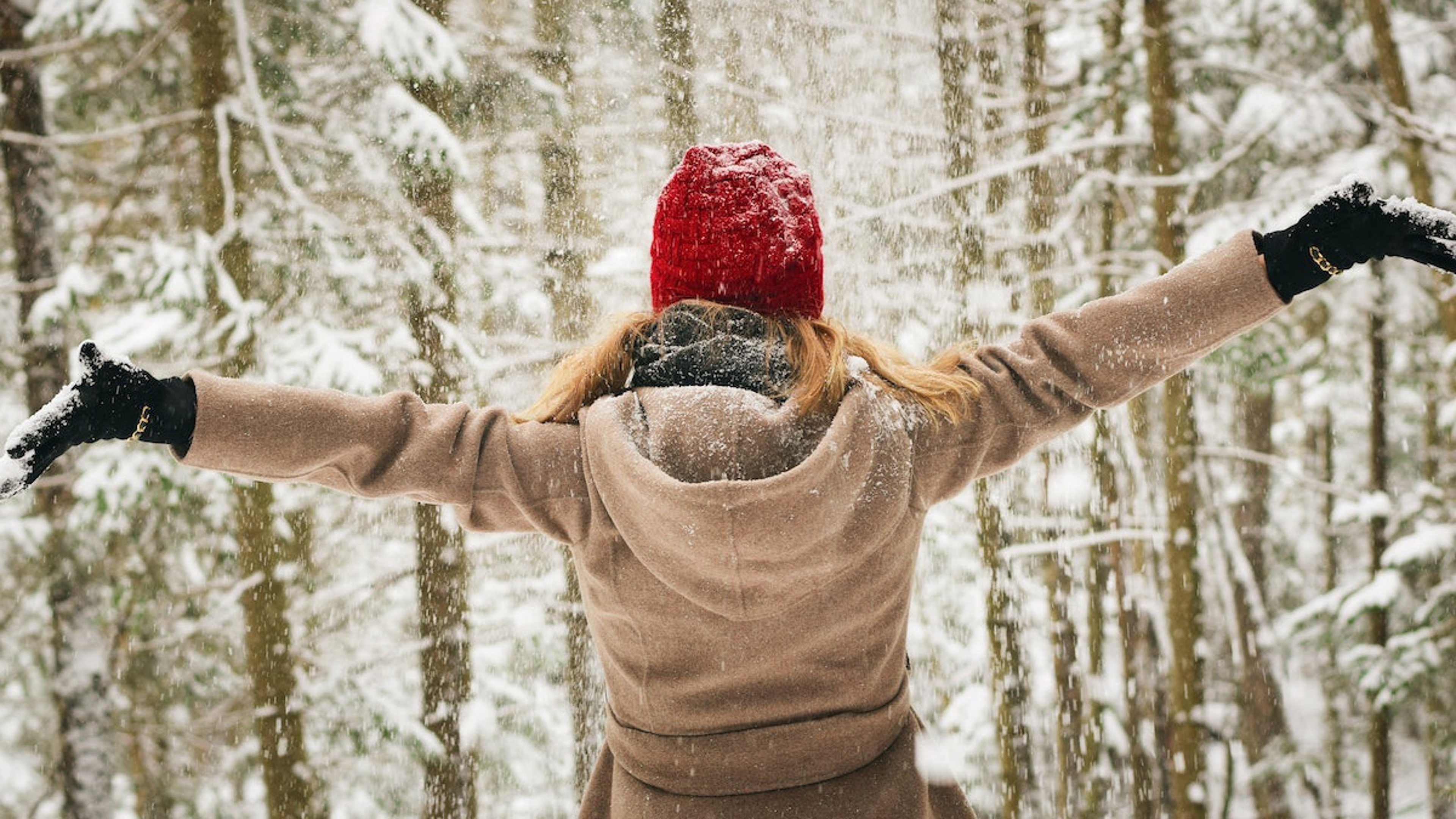 winter quotes woman spreading arms in snow