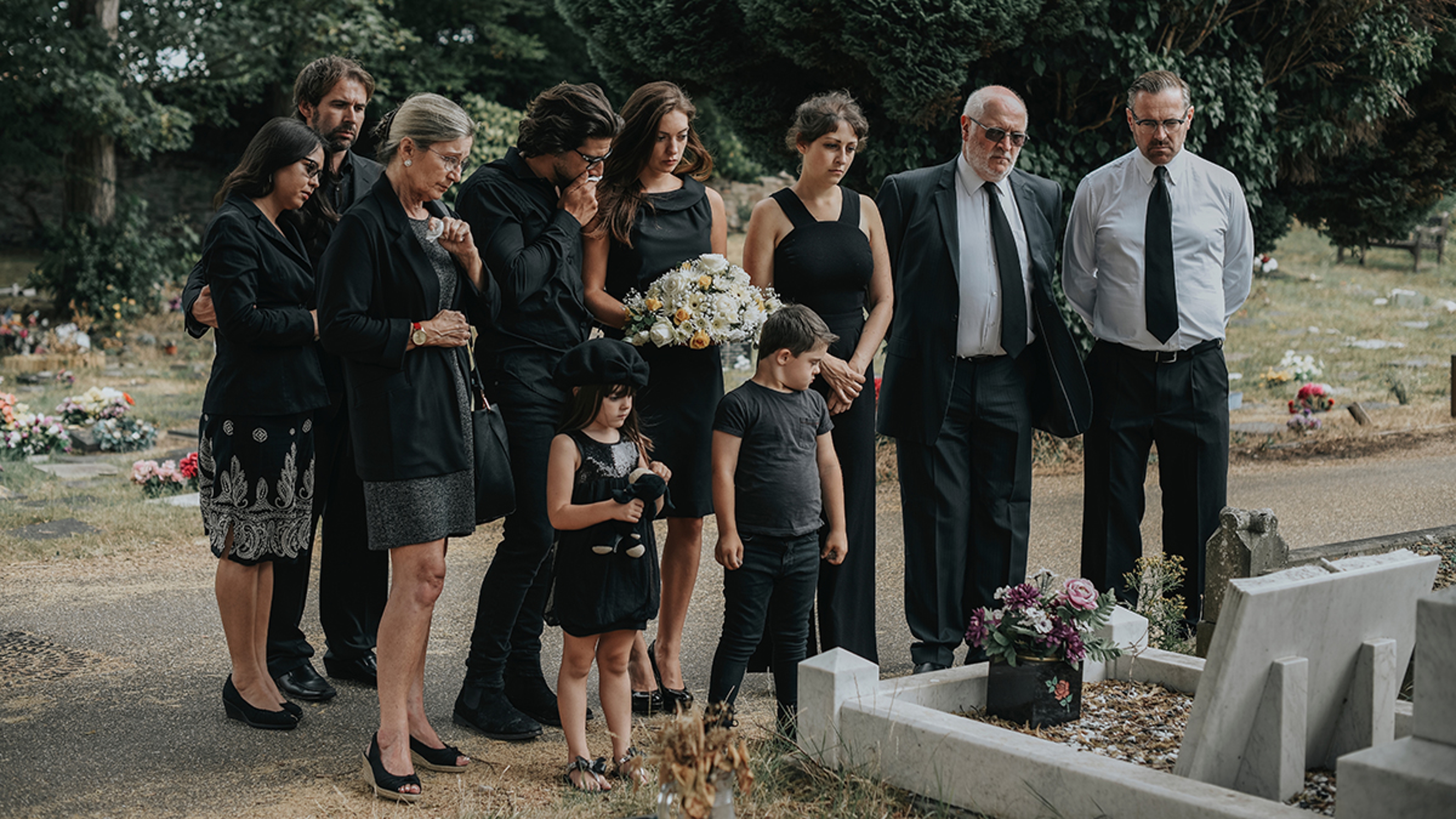 Article Cards Featured Image Family giving their last goodbyes at the cemetery