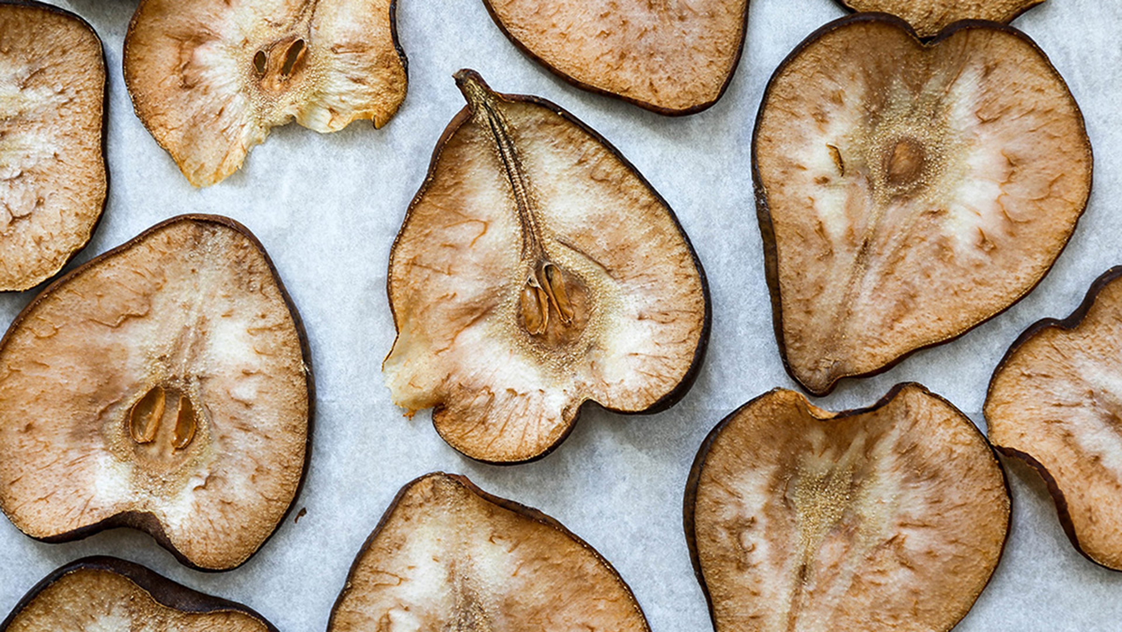 Sliced and baked pears on a cookie sheet.