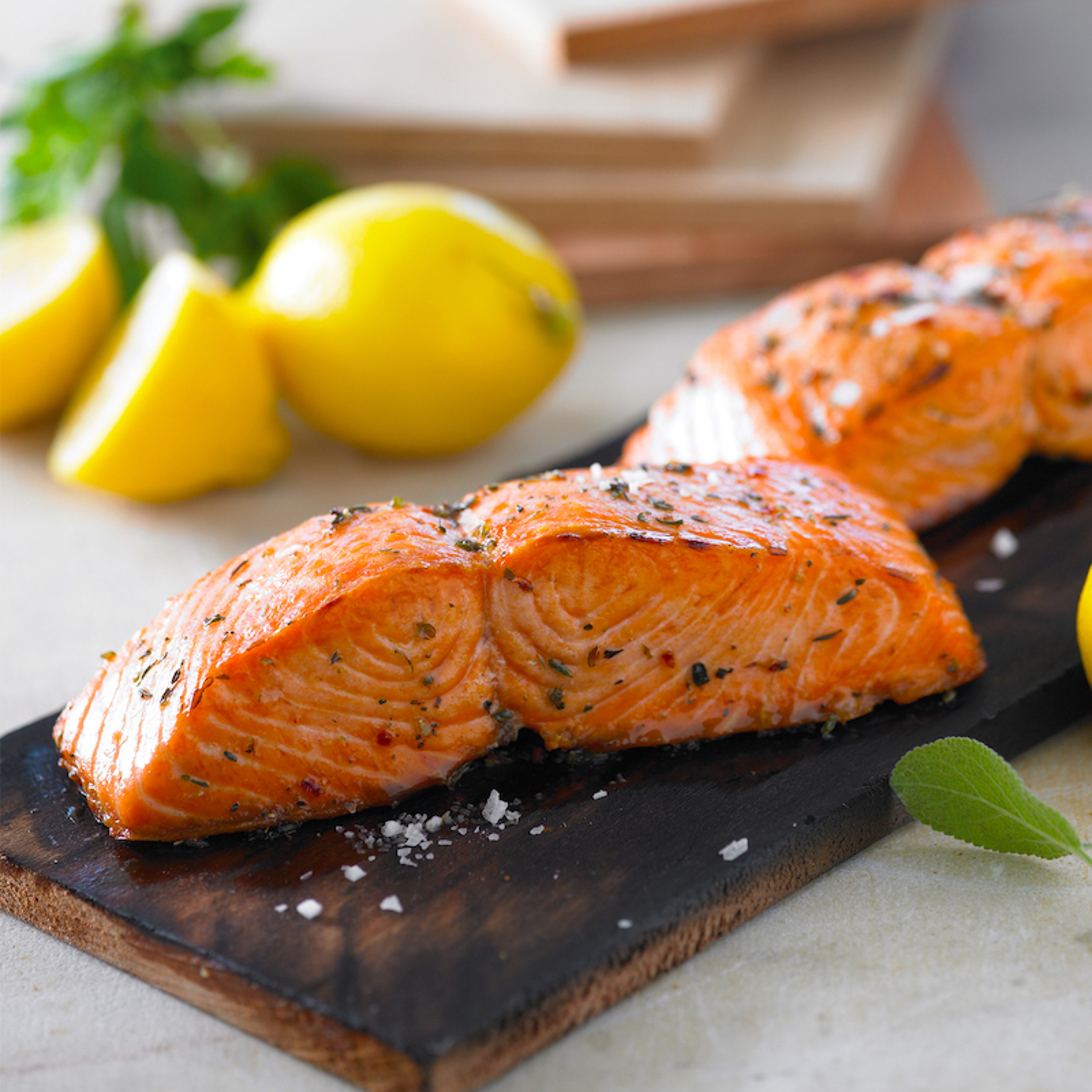 cedar planks grilling salmon fillets on top of cedar planks