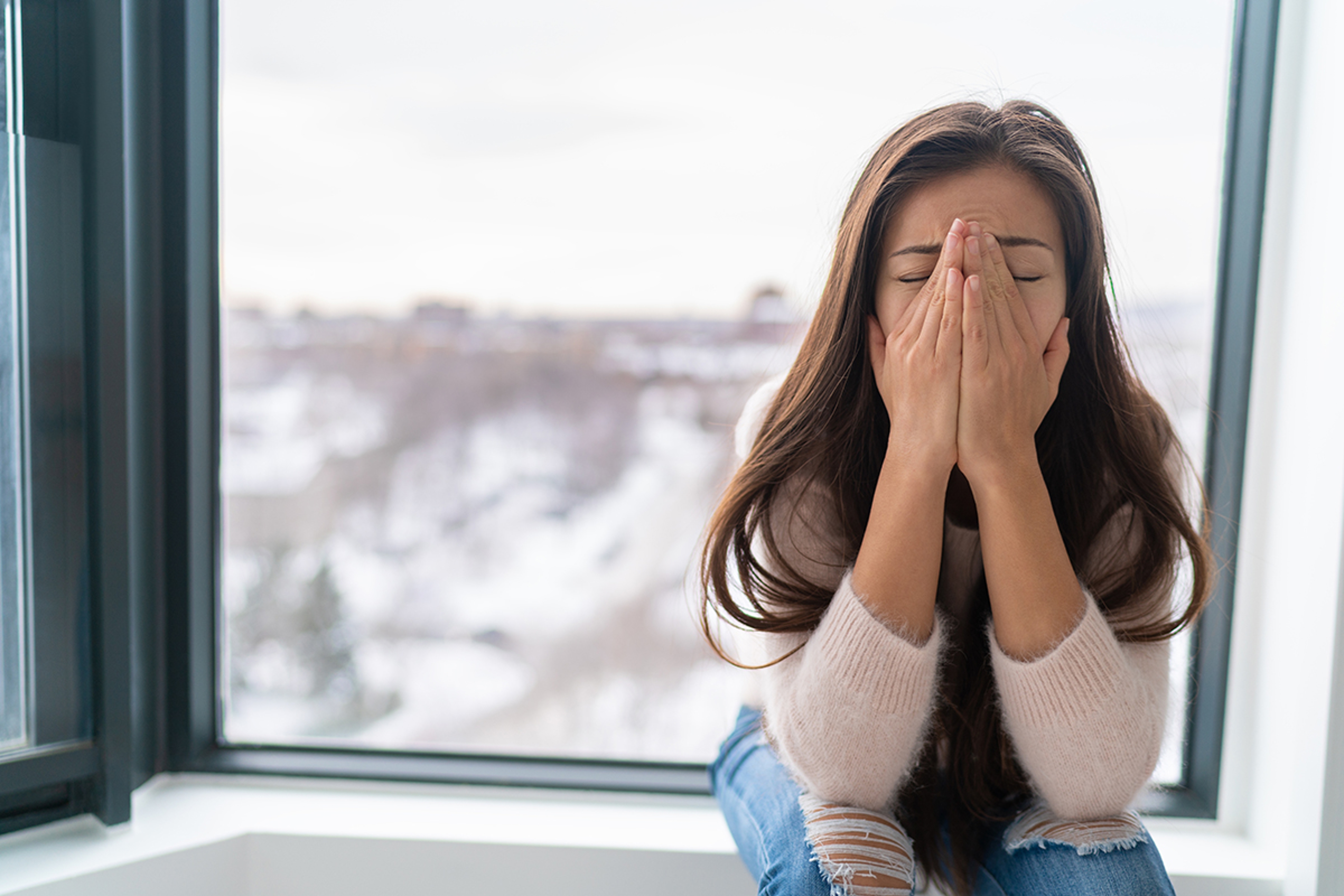 Article Cards Featured Image Anxiety winter depression woman having a panic attack and a hard time breathing. Home alone girl crying stressed depressed.