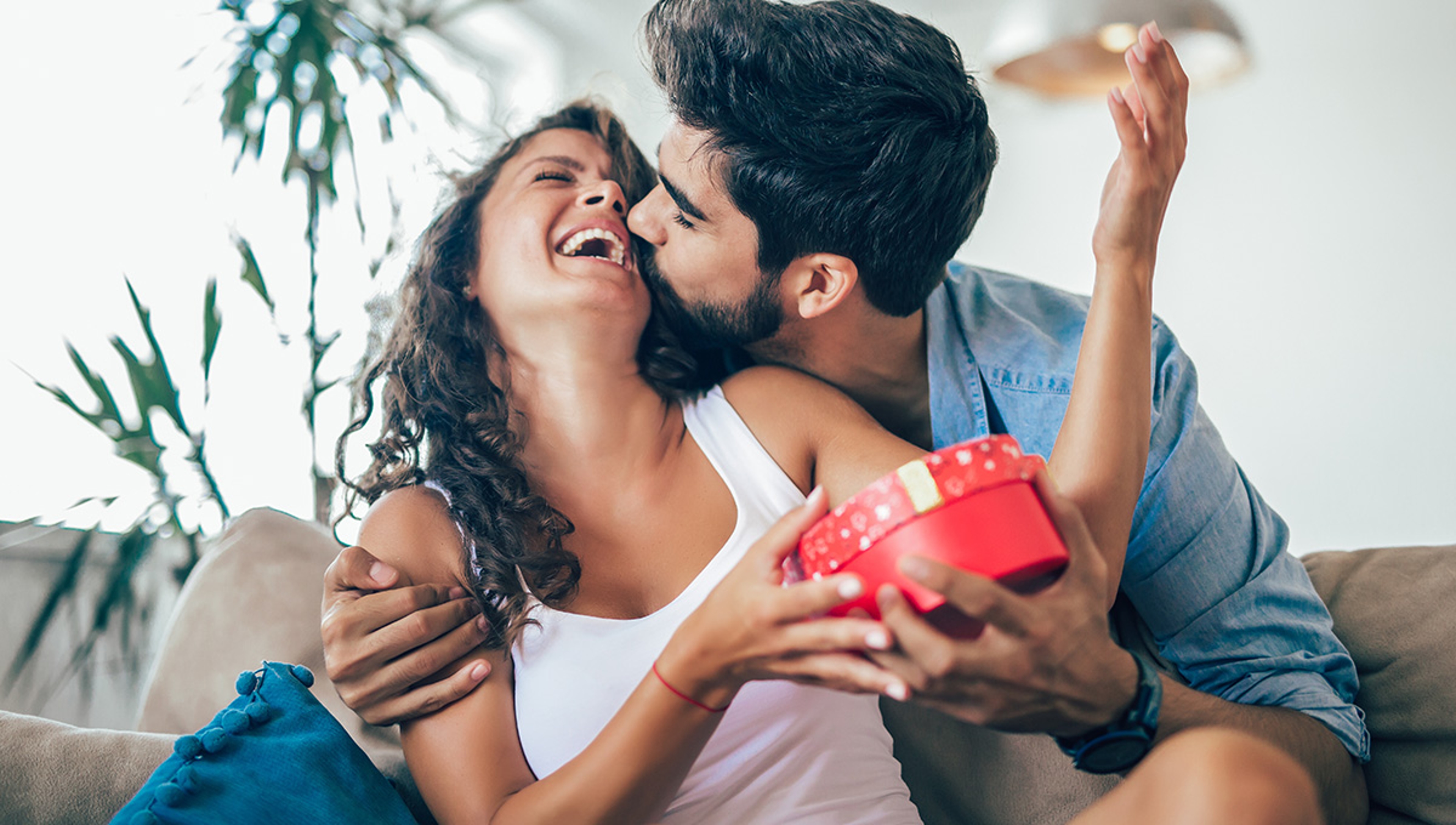 Man giving a surprise gift to woman at home