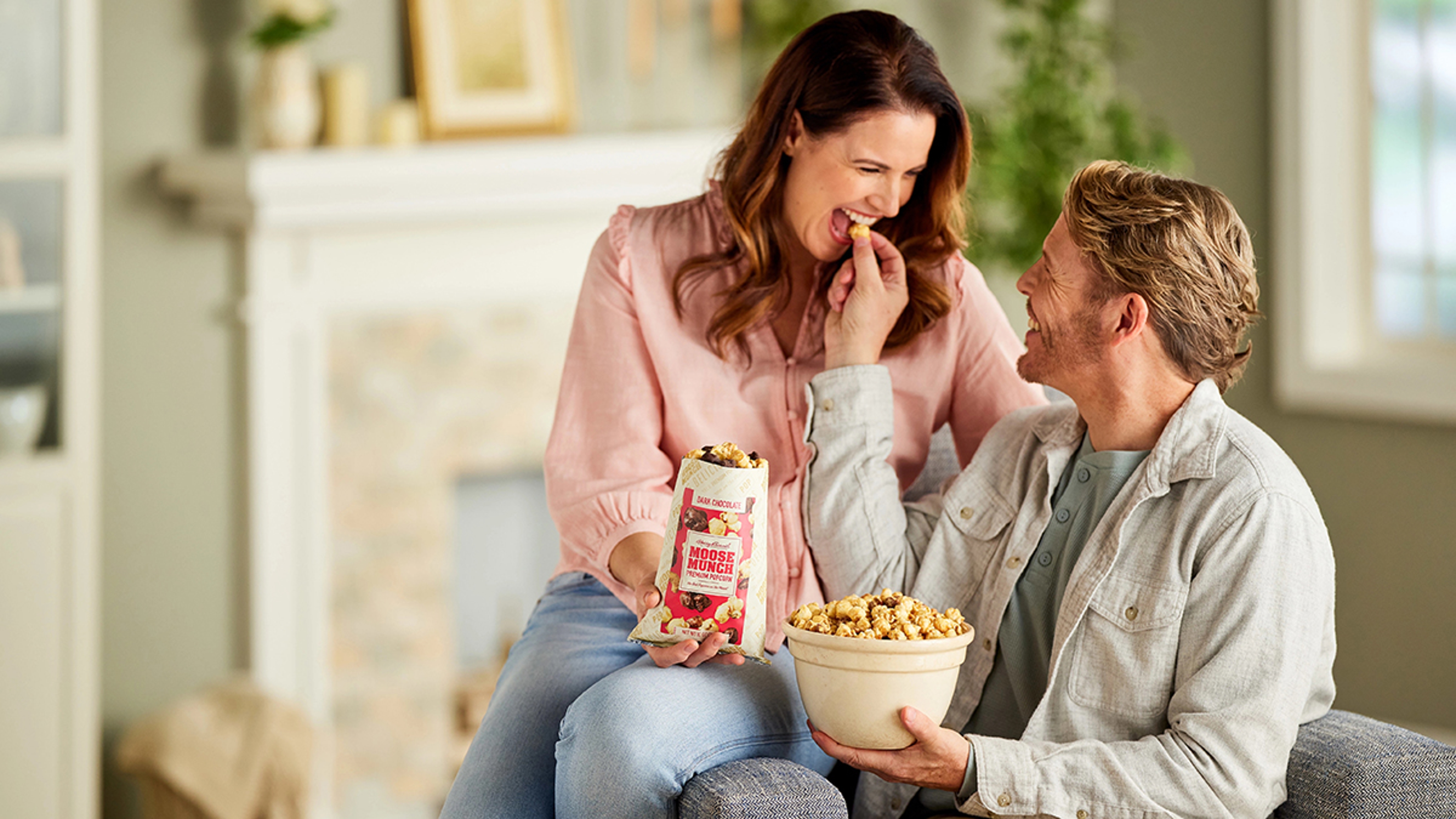 What is a sweet tooth with two people eating Moose Munch popcorn.