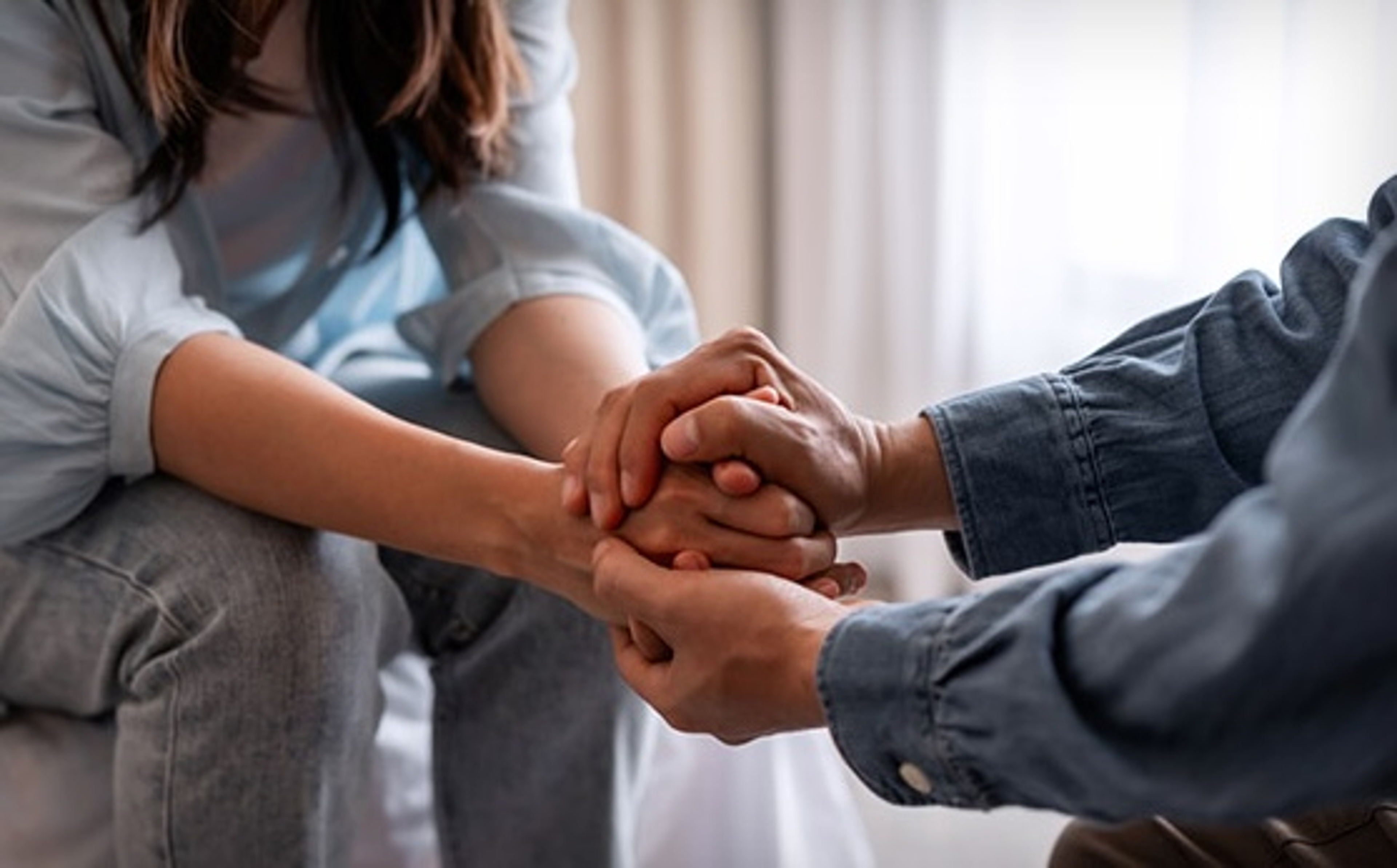 grief words holding hands