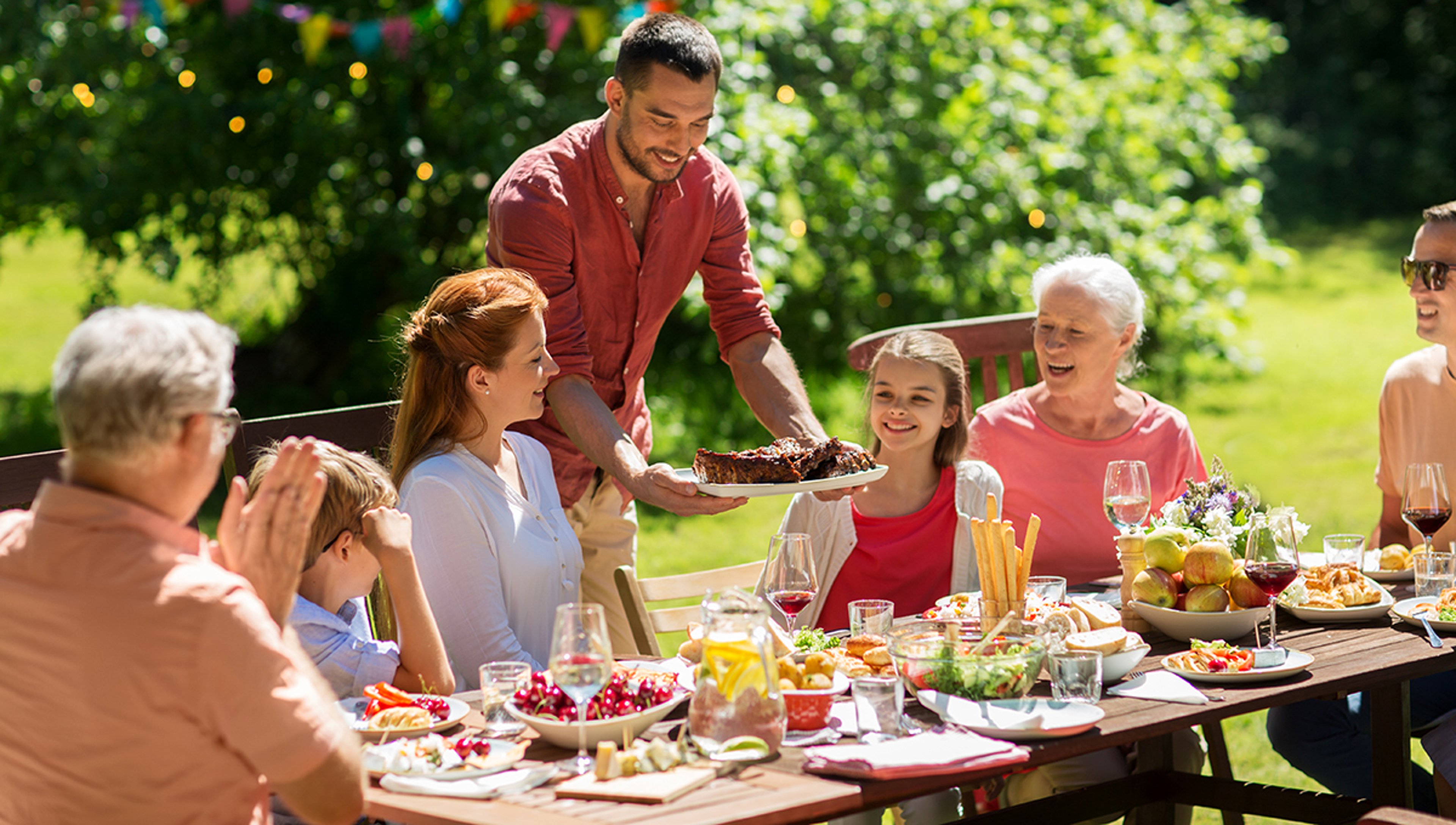 Article Cards Featured Image happy family having dinner or summer garden party