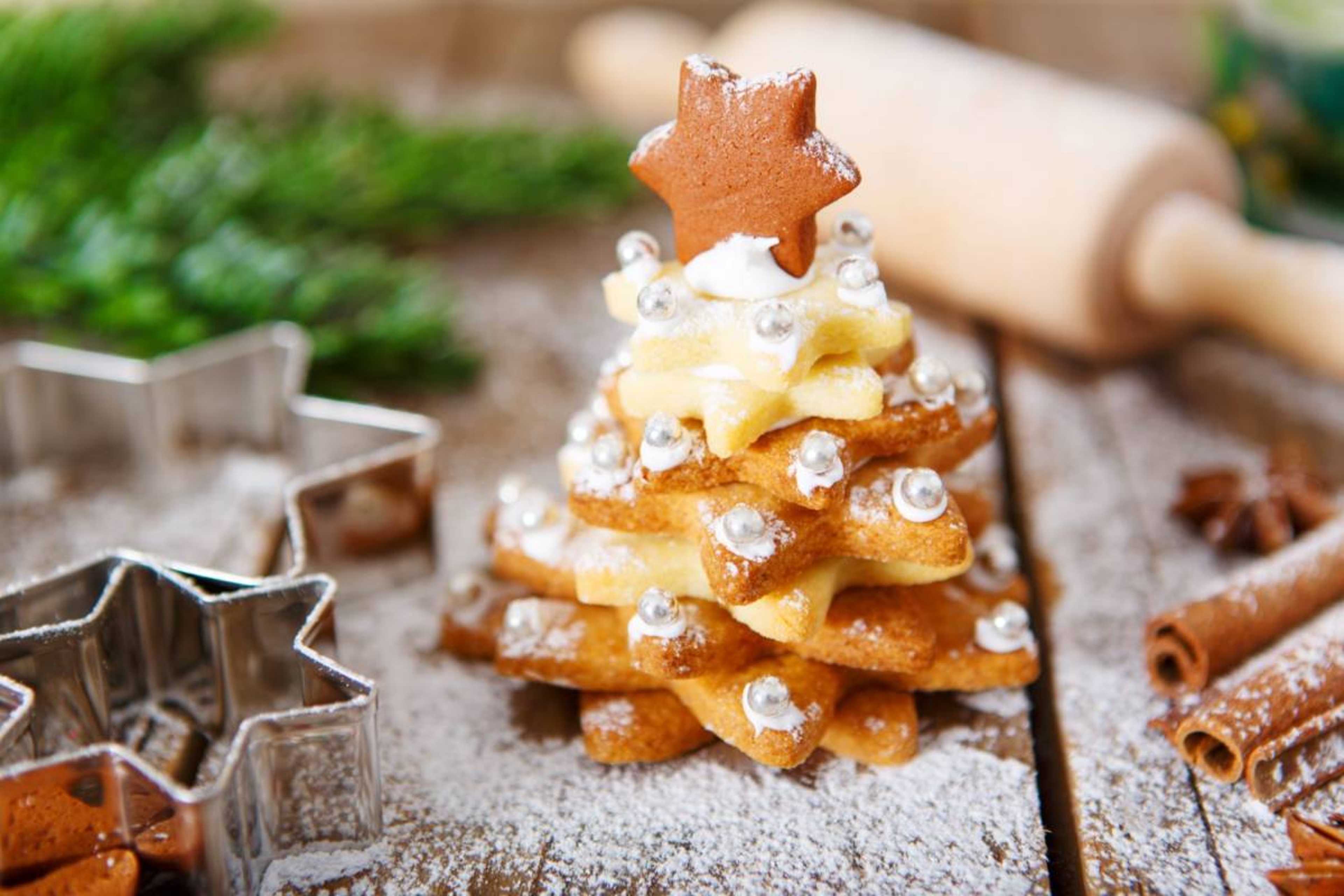 Star shaped sugar cookies stacked up and decorated as a Christmas tree