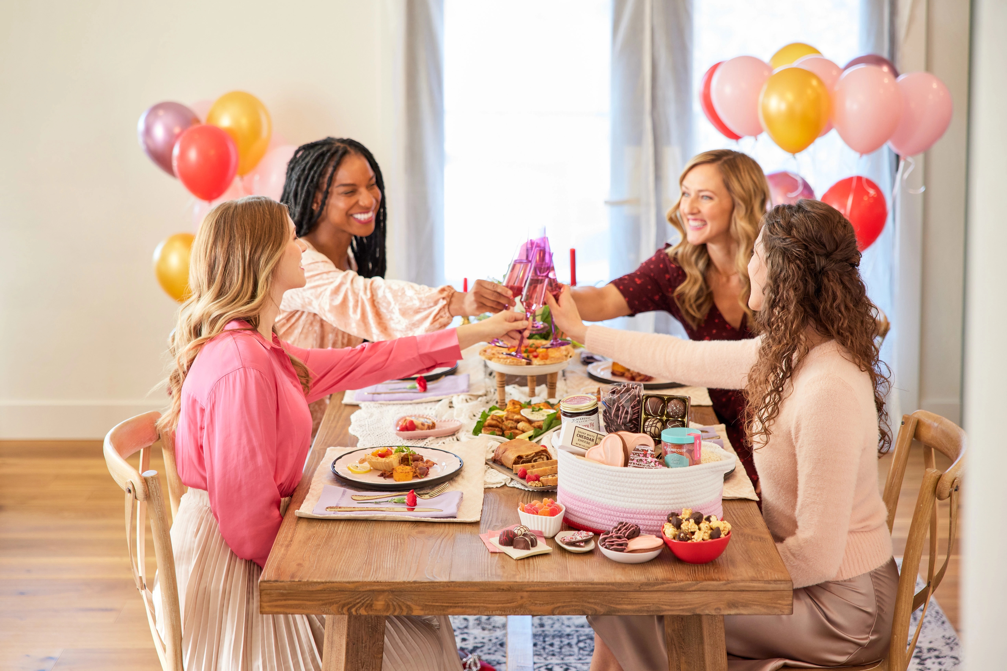 Article Cards Featured Image galentines day party ideas hero four women toasting at a table