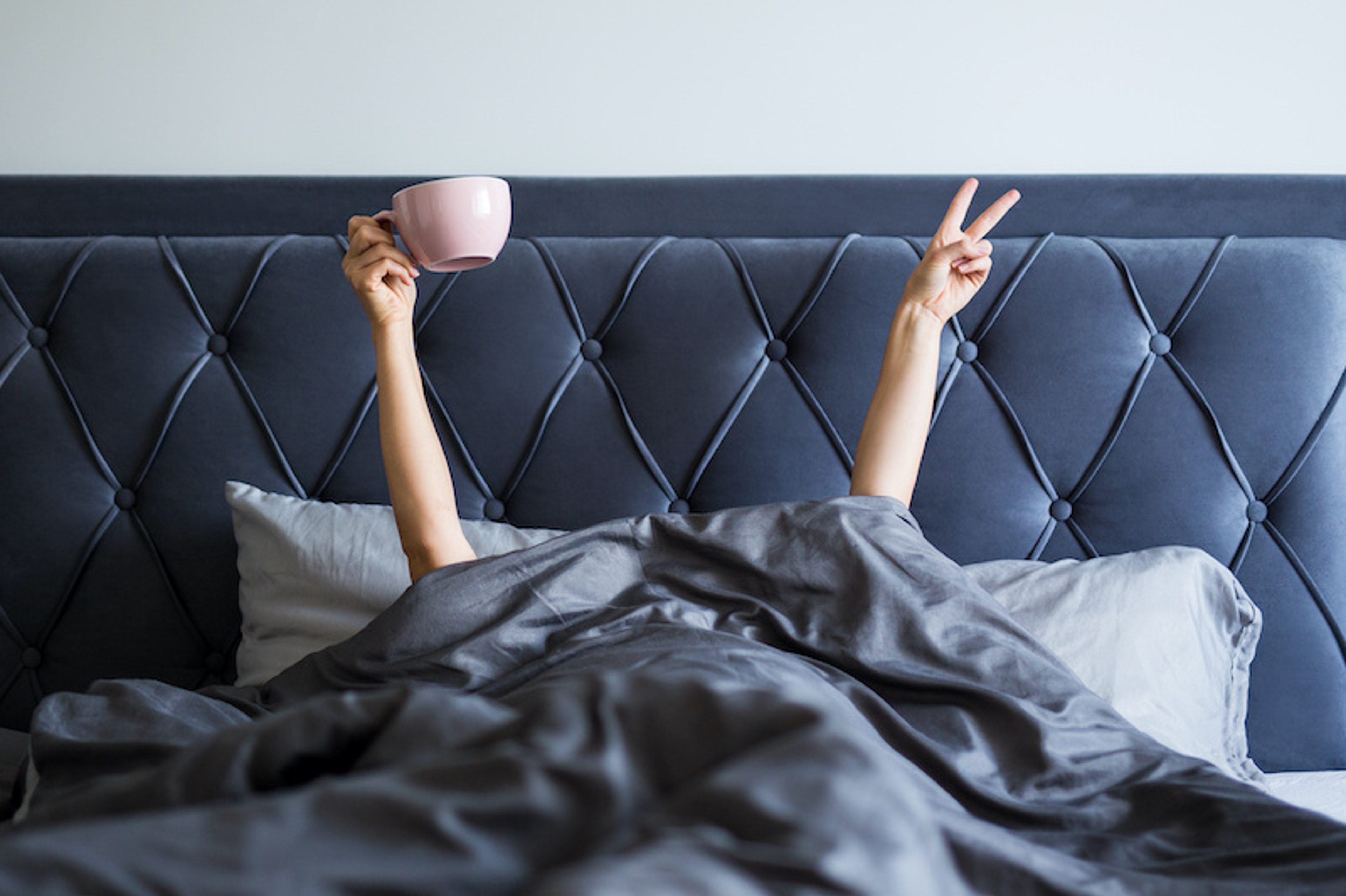 waking woman with coffee mug in hand