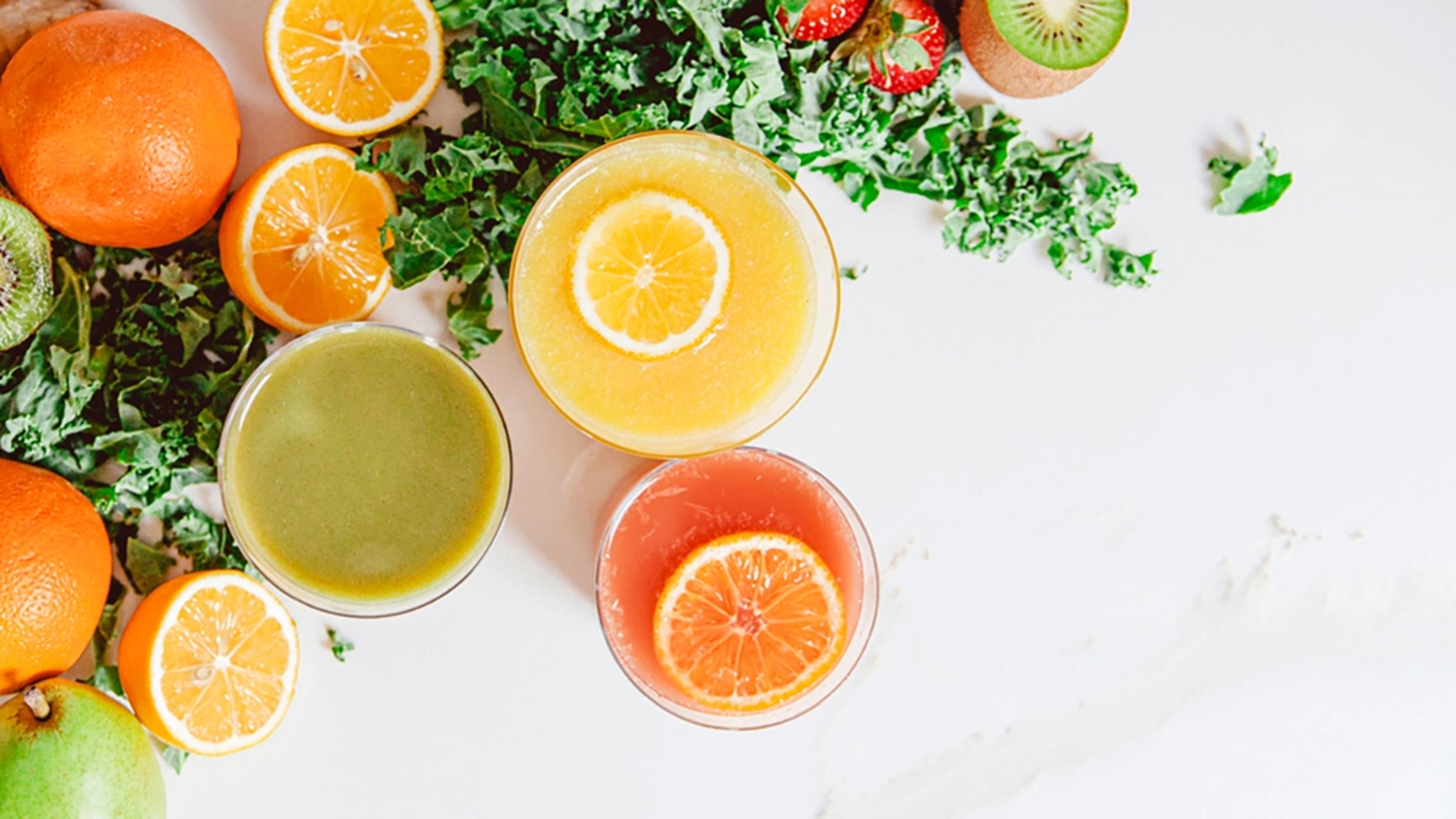 Two cups of fresh juice with fruit and vegetables