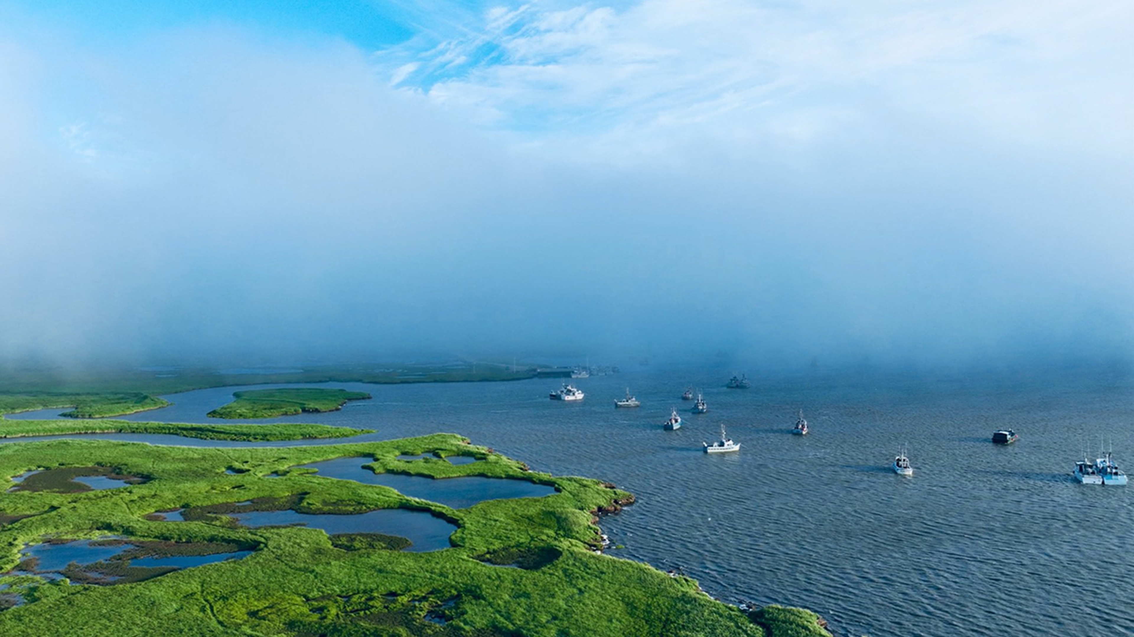 Guide to Bristol Bay with an overhead shot of the bay with boats.