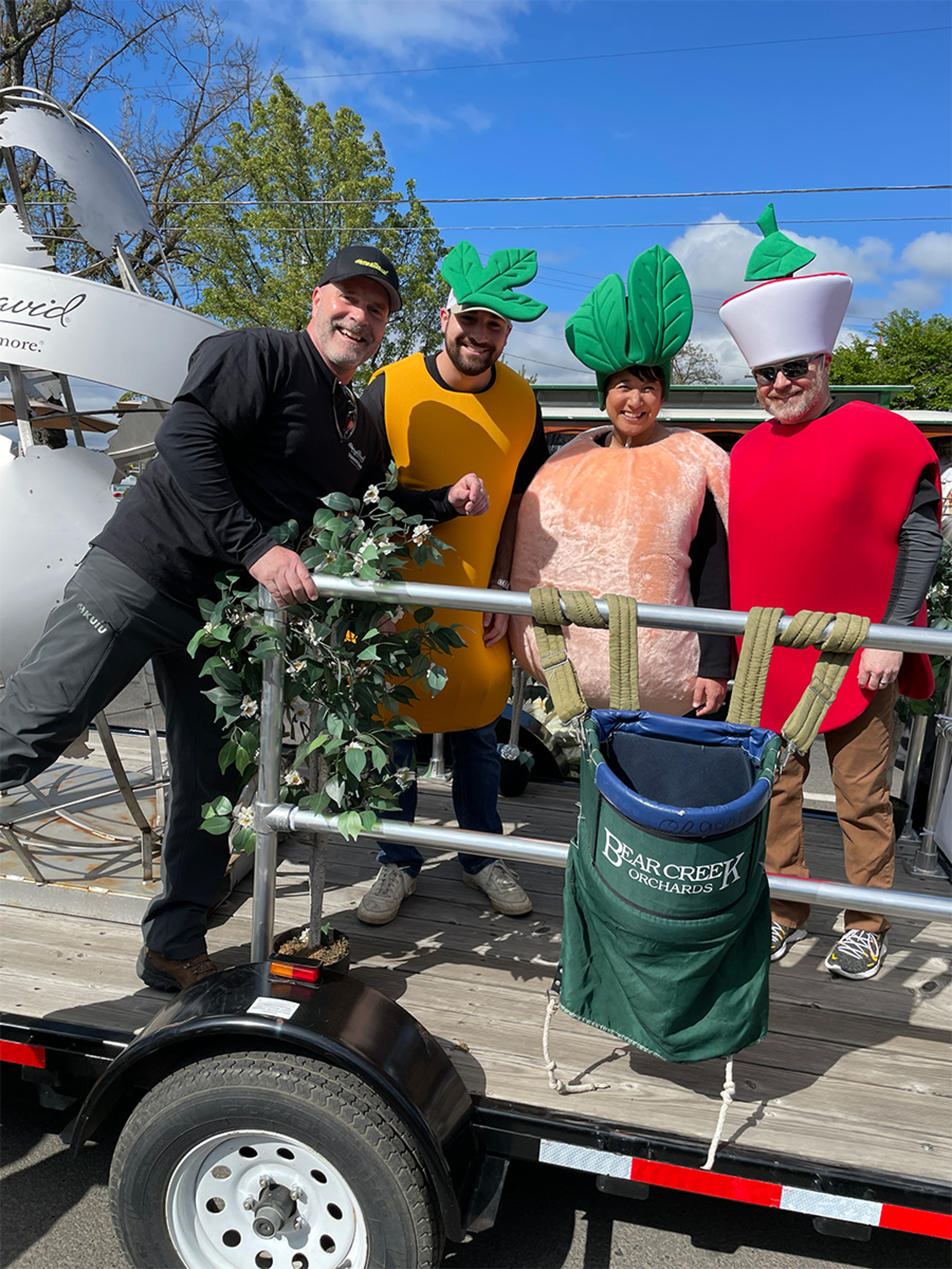 Chris Genereux and son with two other people at a parade.