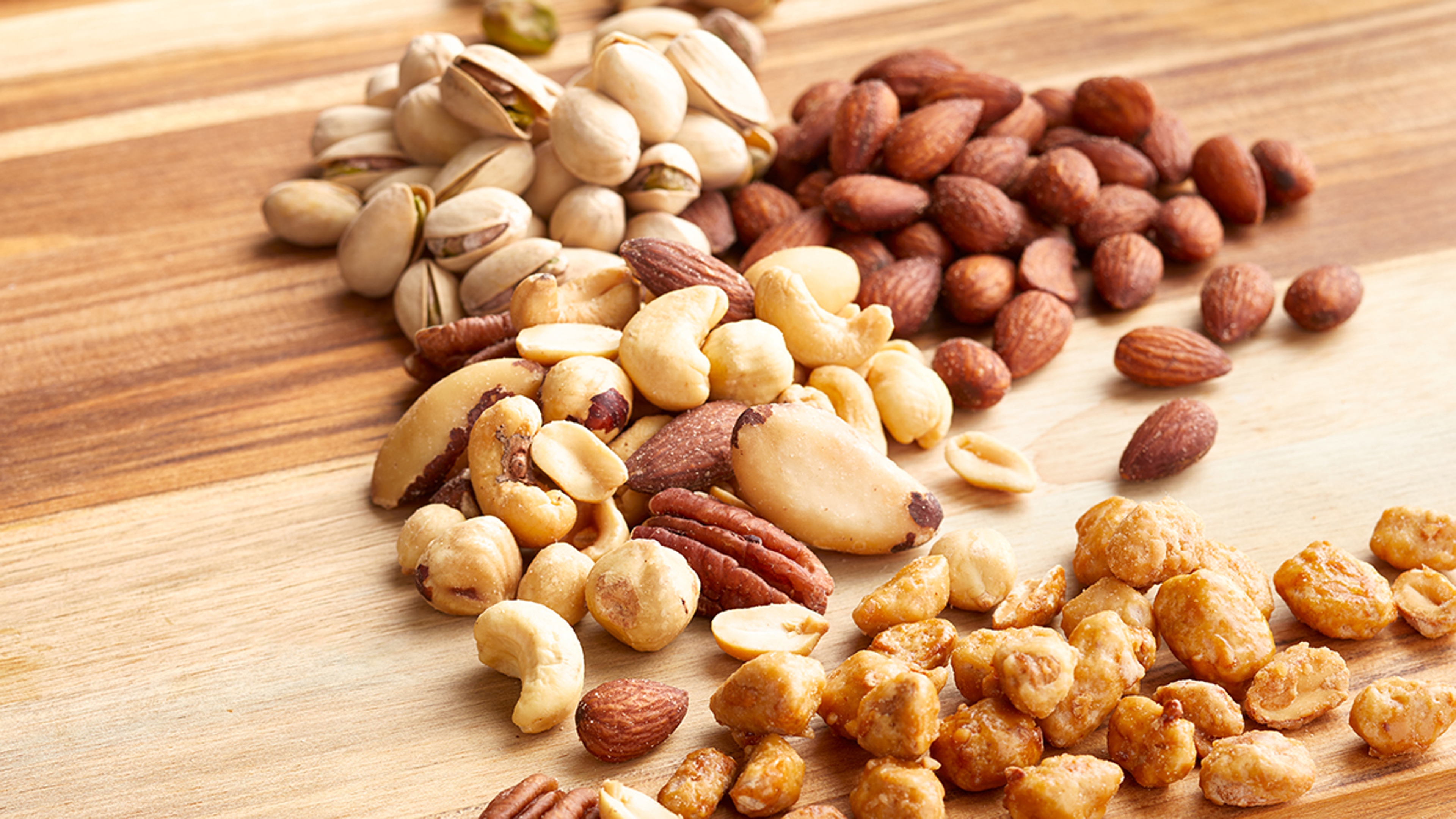 How to store nuts with a spread of mixed nuts on a wooden table.