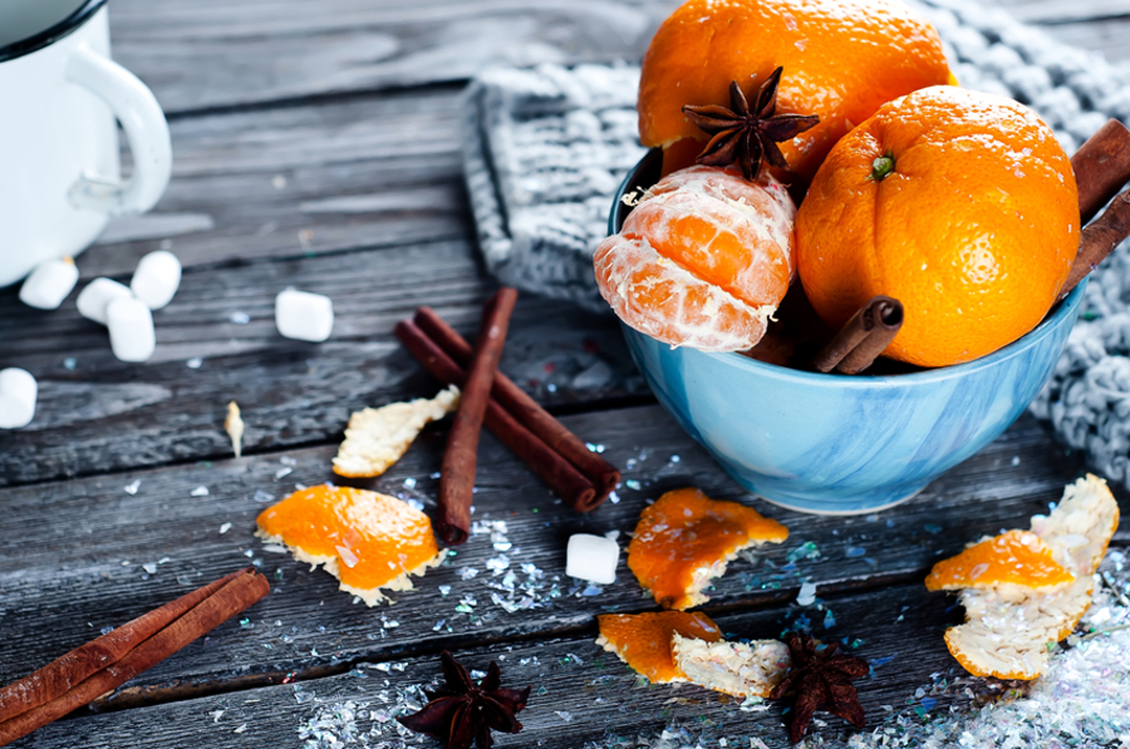 Article Cards Featured Image Tangerine in scarf over wooden background with snow and leaf.