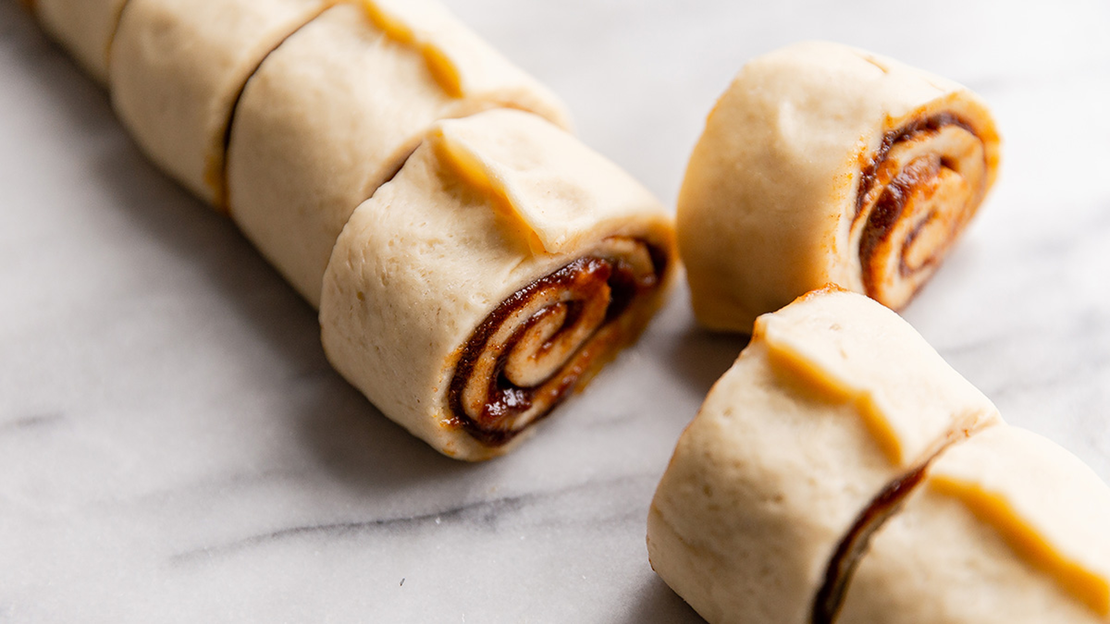 Raw cinnamon rolls freshly sliced before baking.