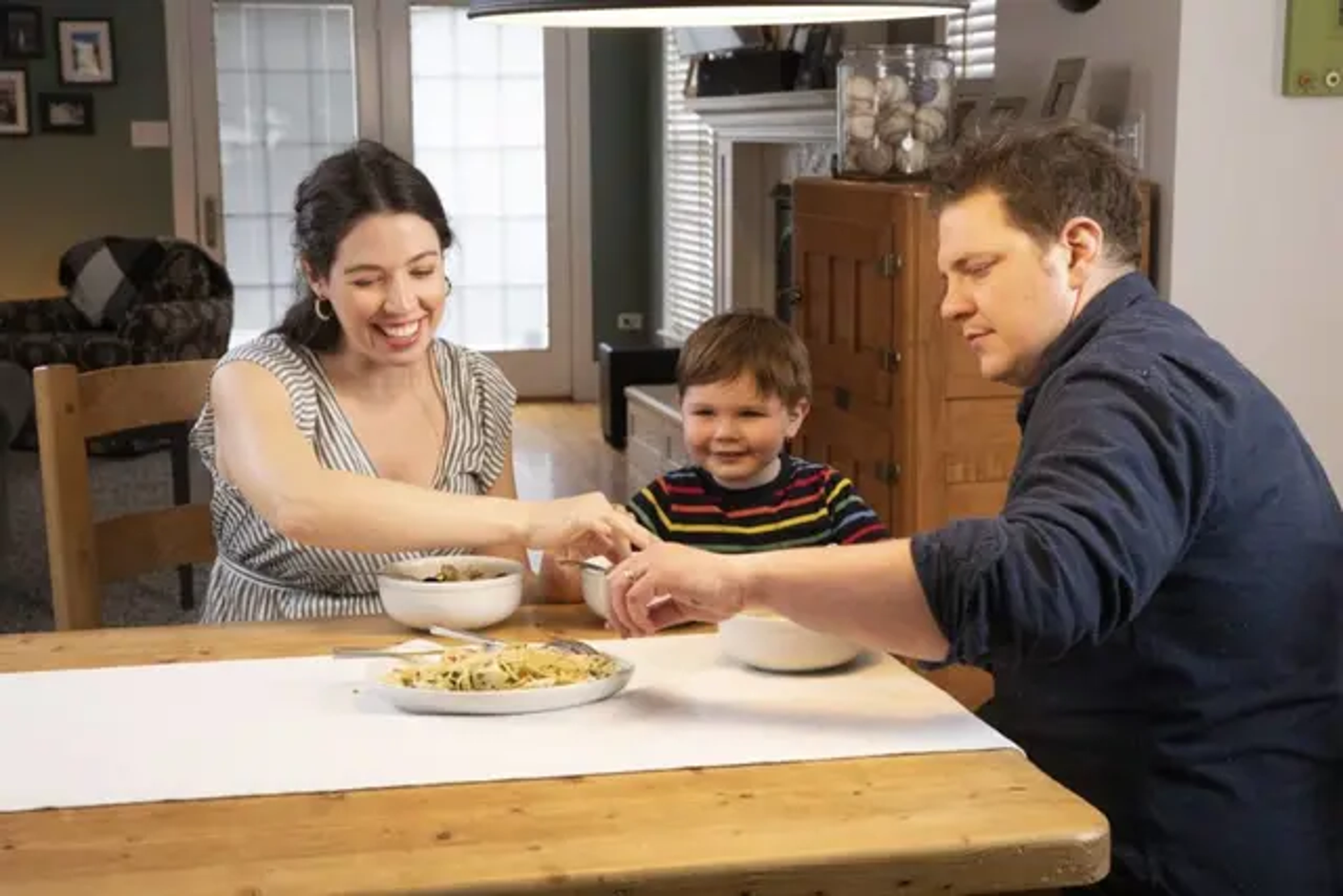 Joe Flamm sitting around a dinning table with his family