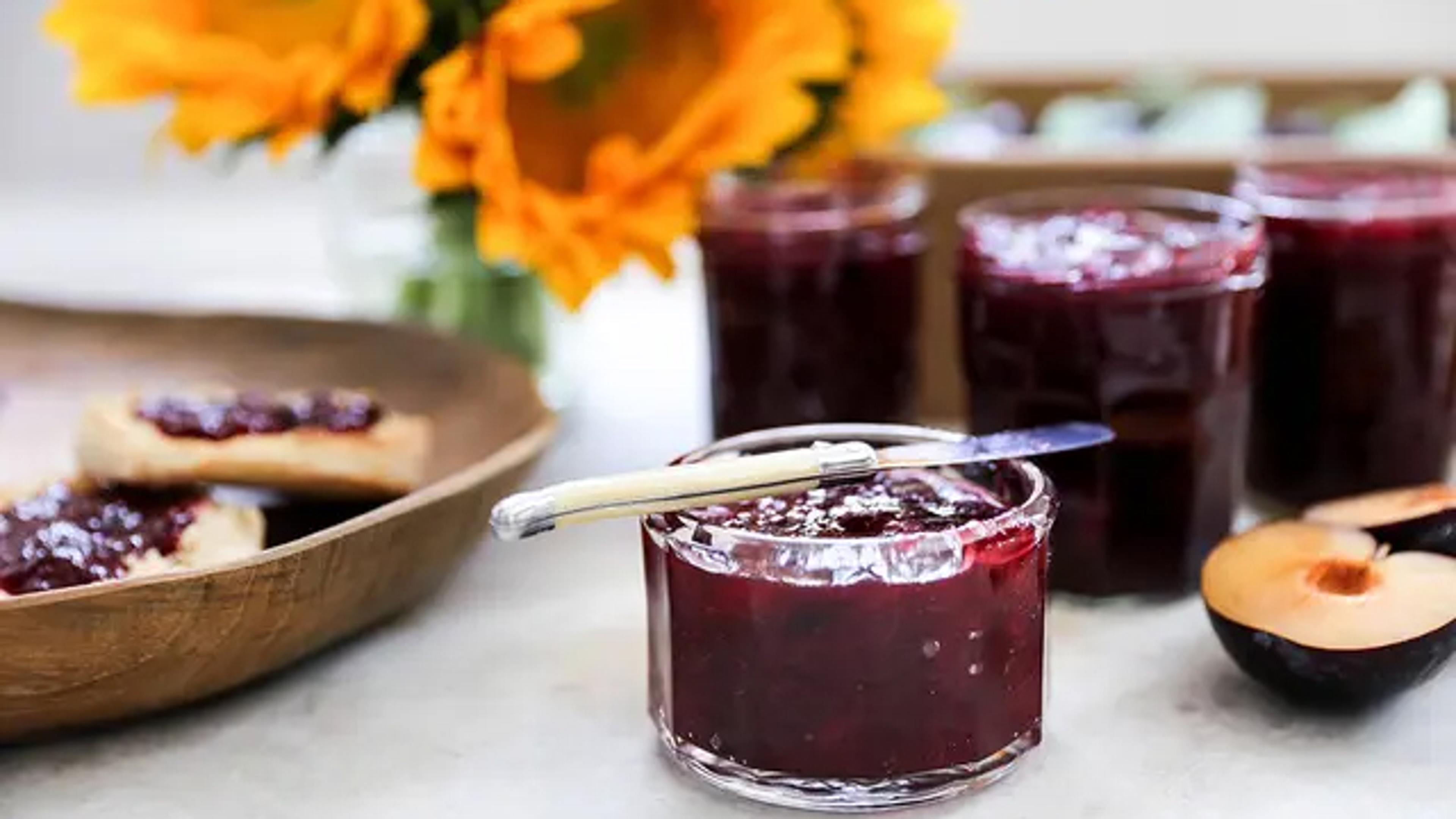 Breakfast ideas with several jars of plum jam.