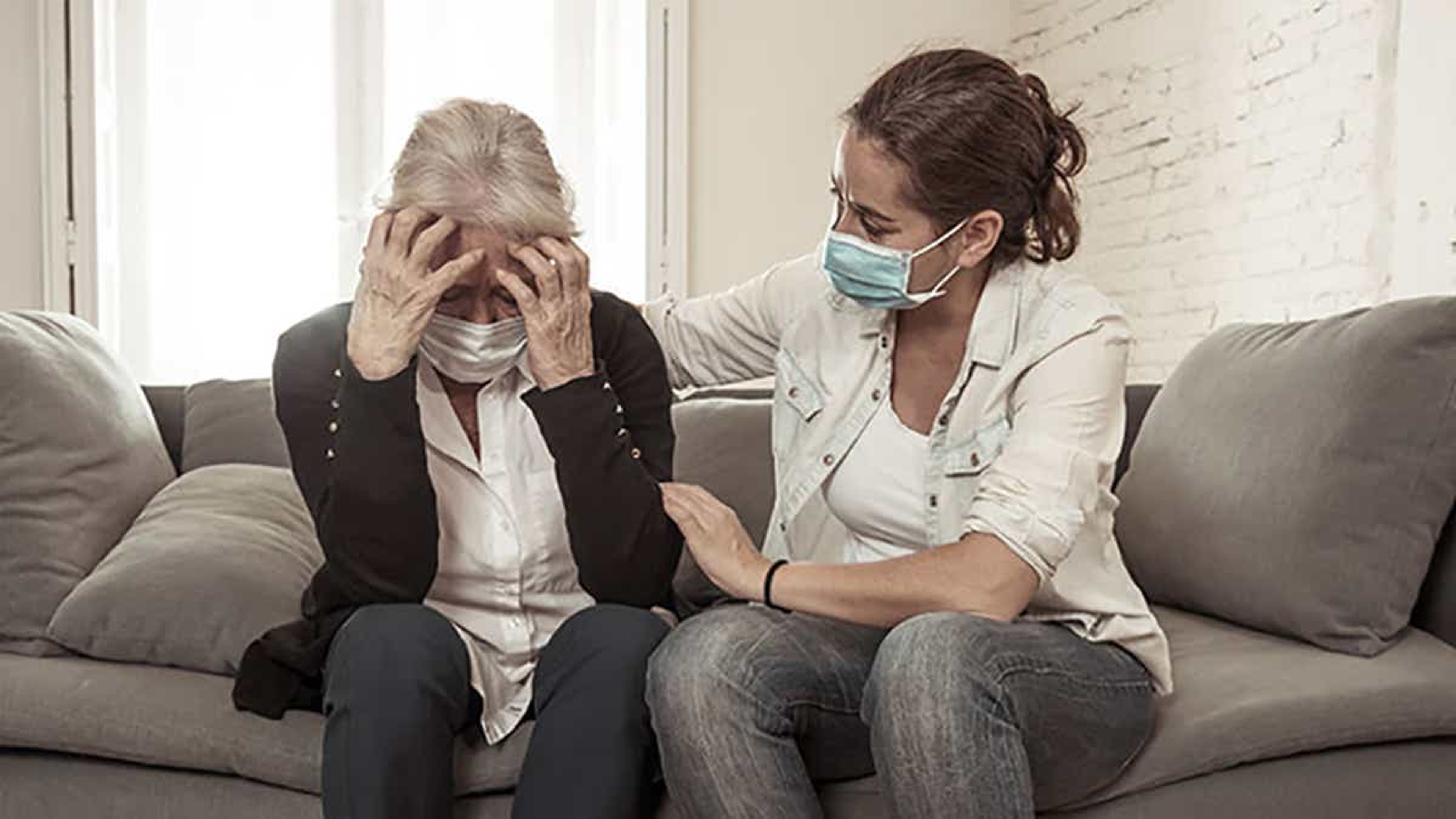 Article Cards Featured Image Woman wearing mask comforting older woman