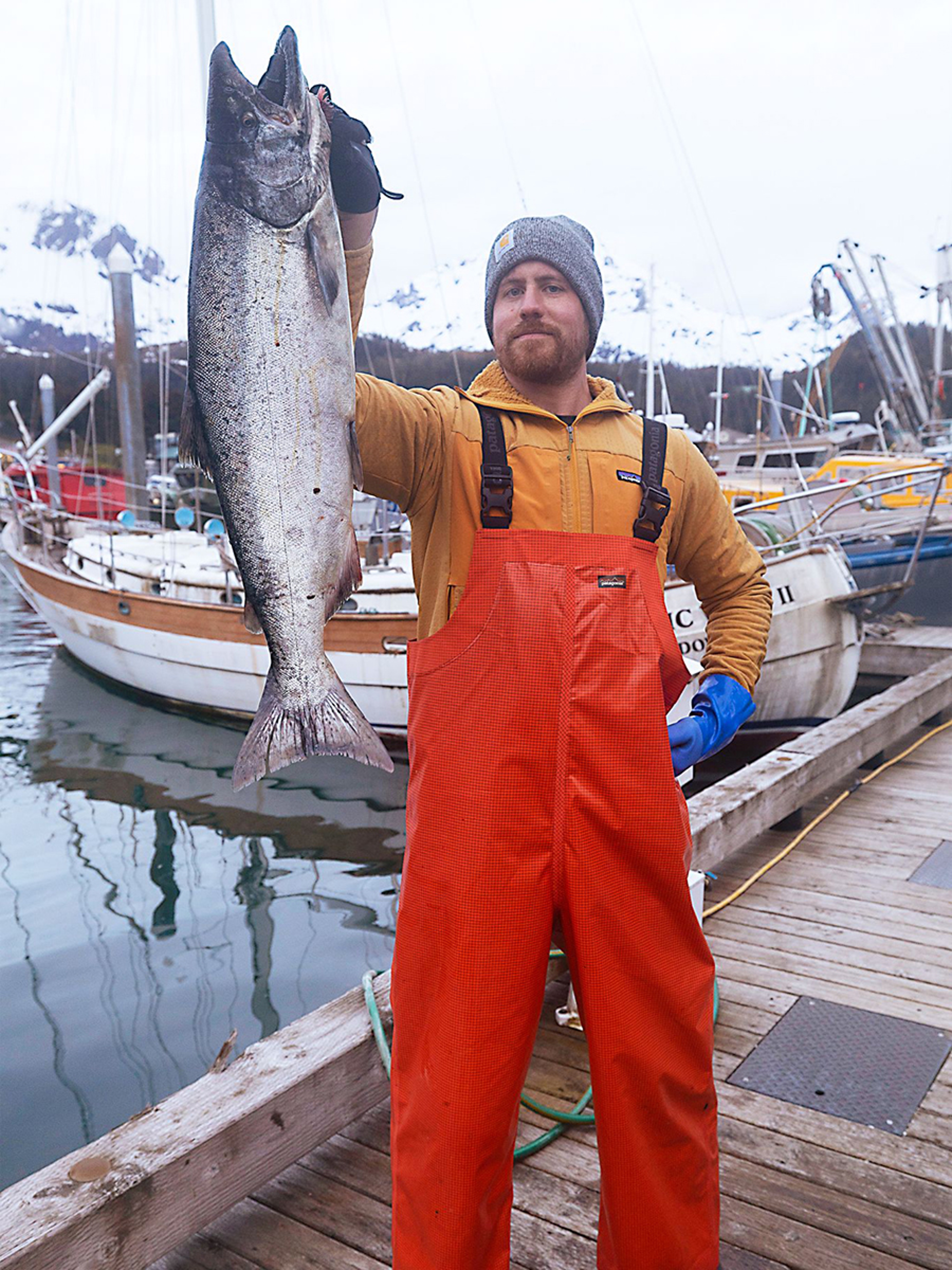 Fisherman holding up a fish.