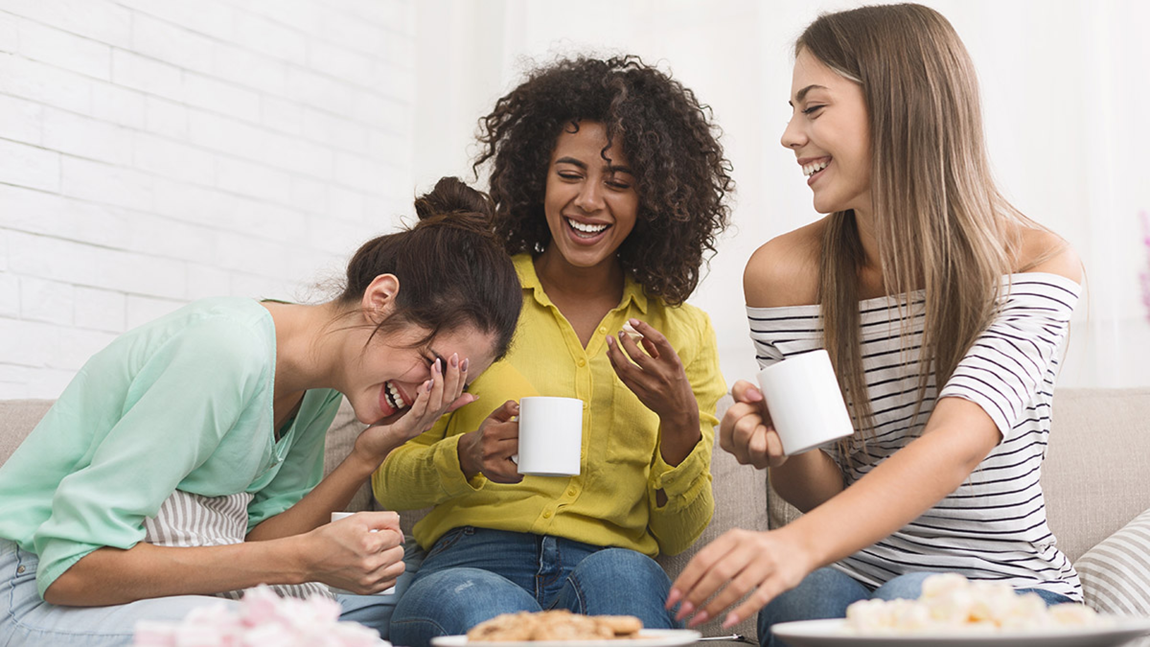 group of friends drinking coffee and eating cookies