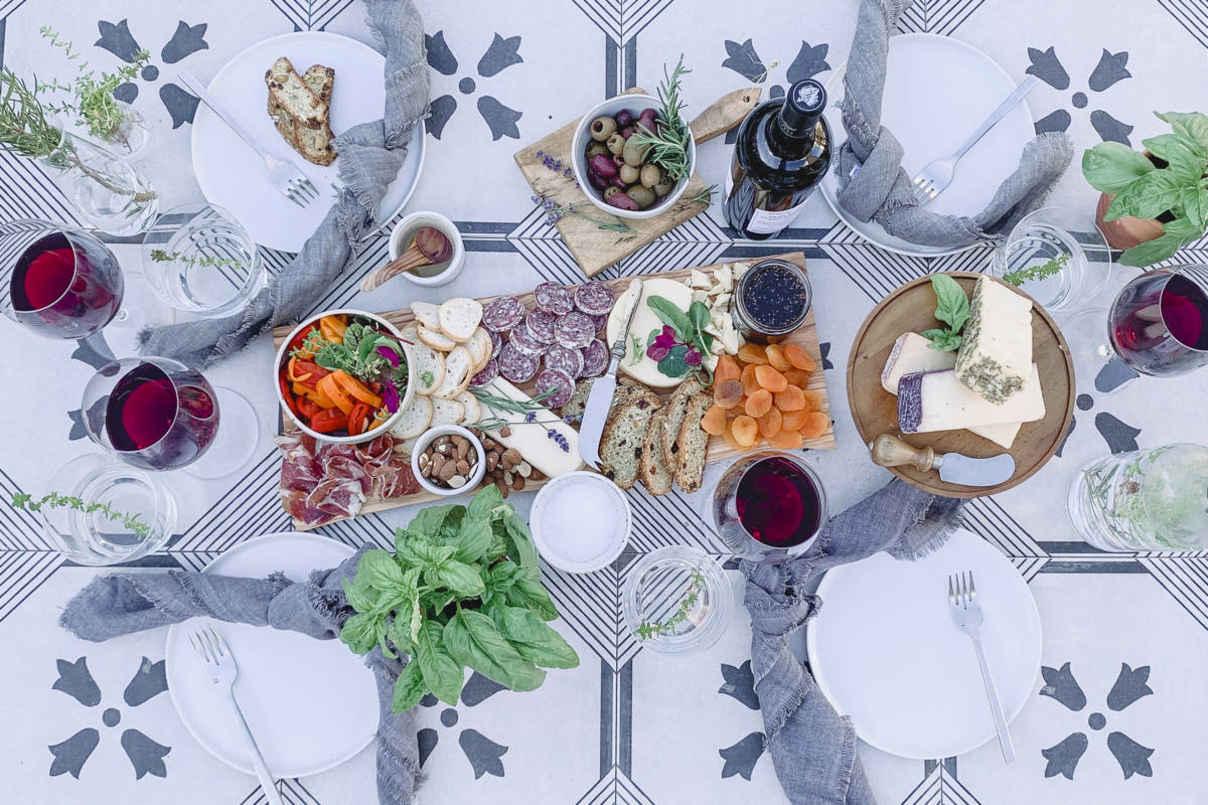 Table laid with food and drink for an Italian inspired backyard vacation.