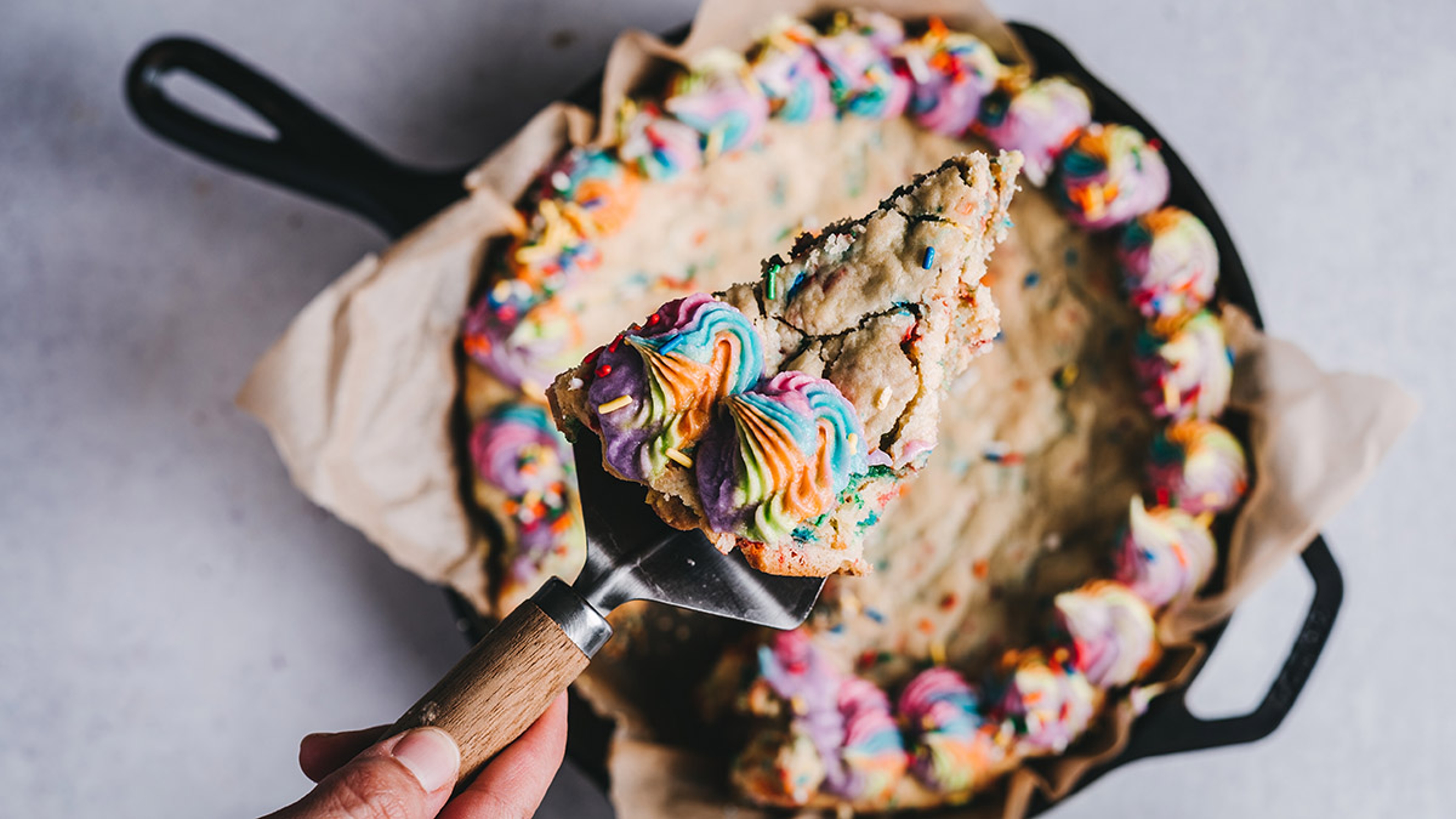 Article Cards Featured Image Cheryl's Cookies cookie cake with rainbow sprinkles and rainbow icing