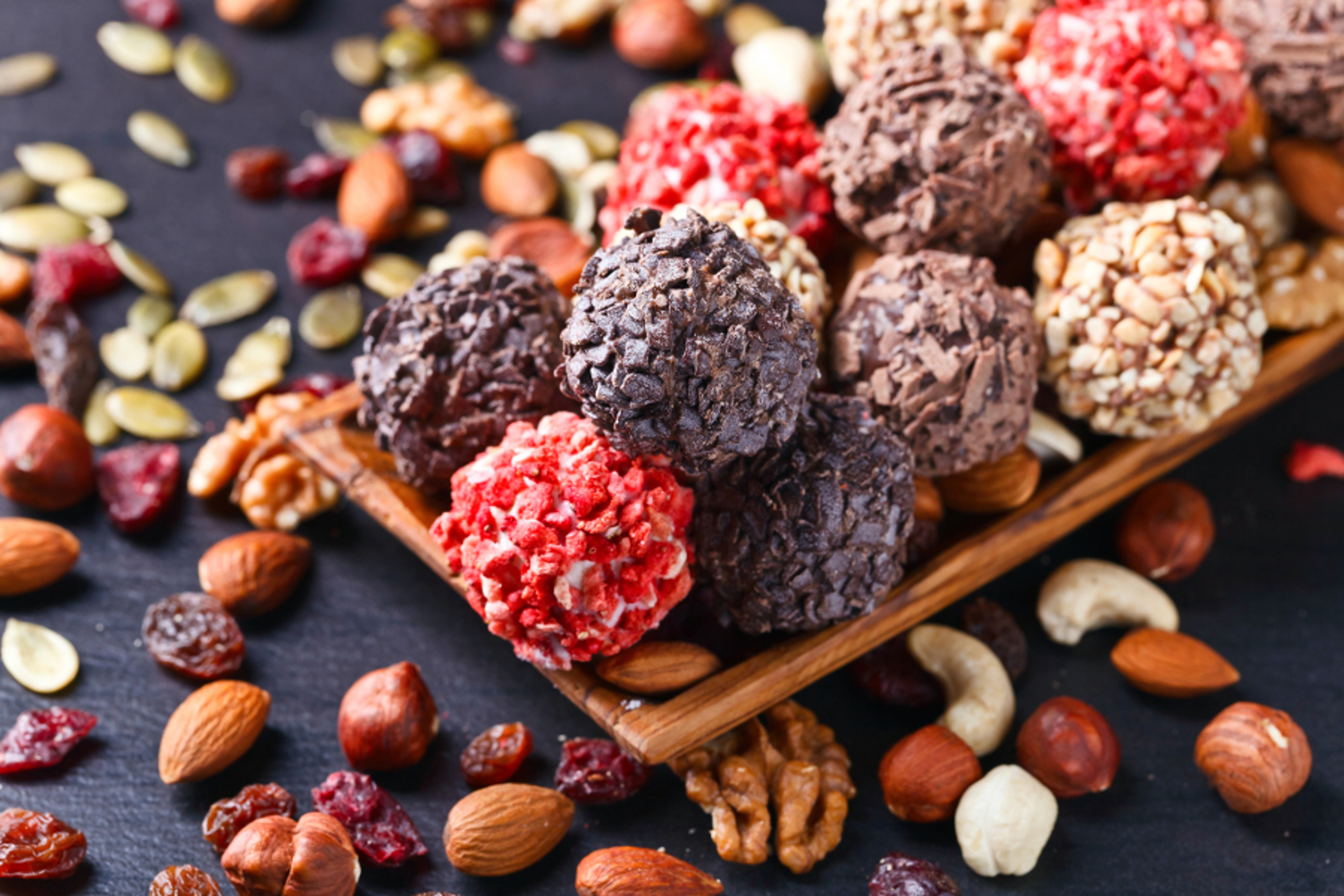 Article Cards Featured Image Homemade candy with chocolate , nuts and dried strawberry on a black table