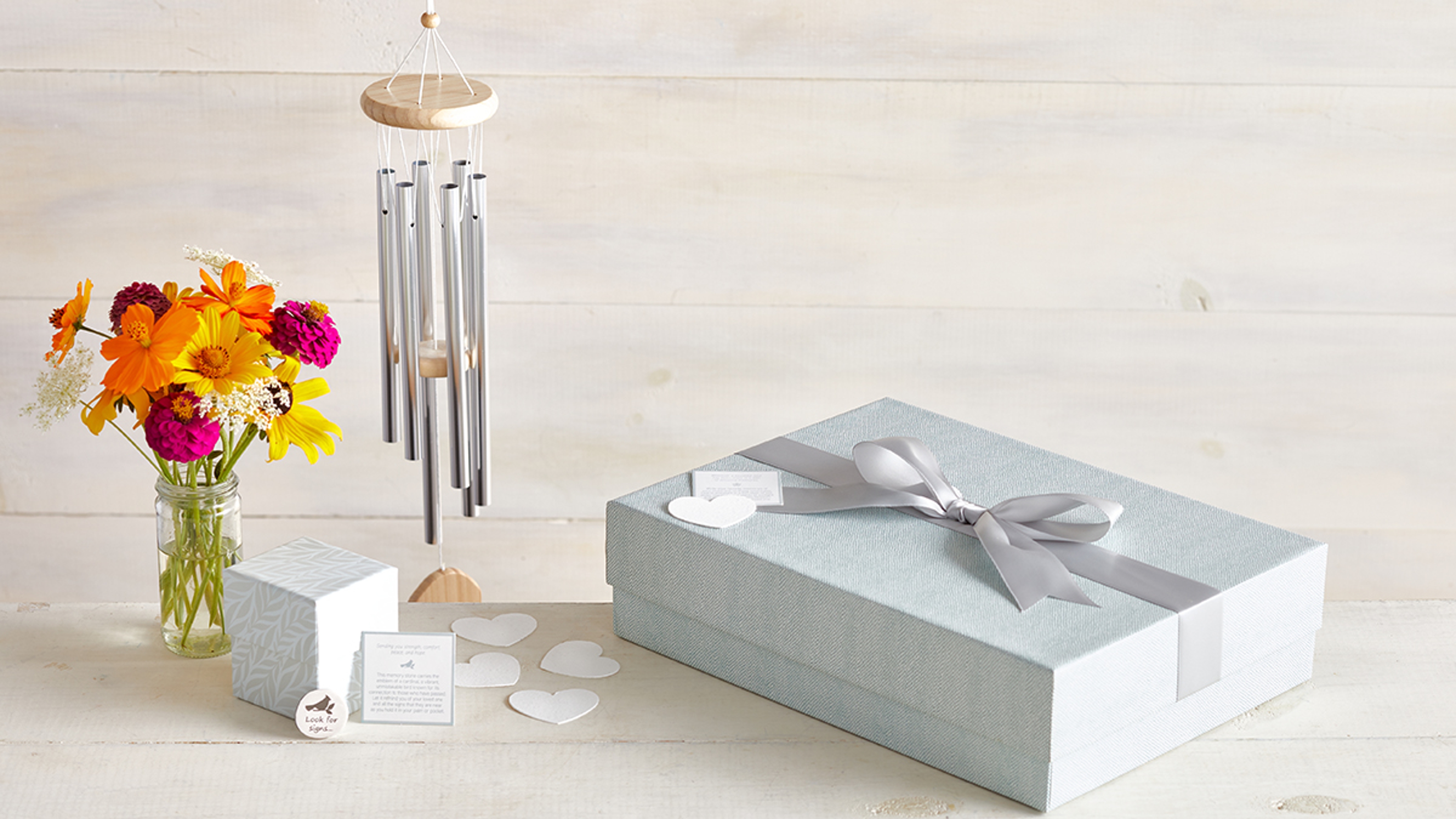 Sympathy gift box with wind chimes and flowers.