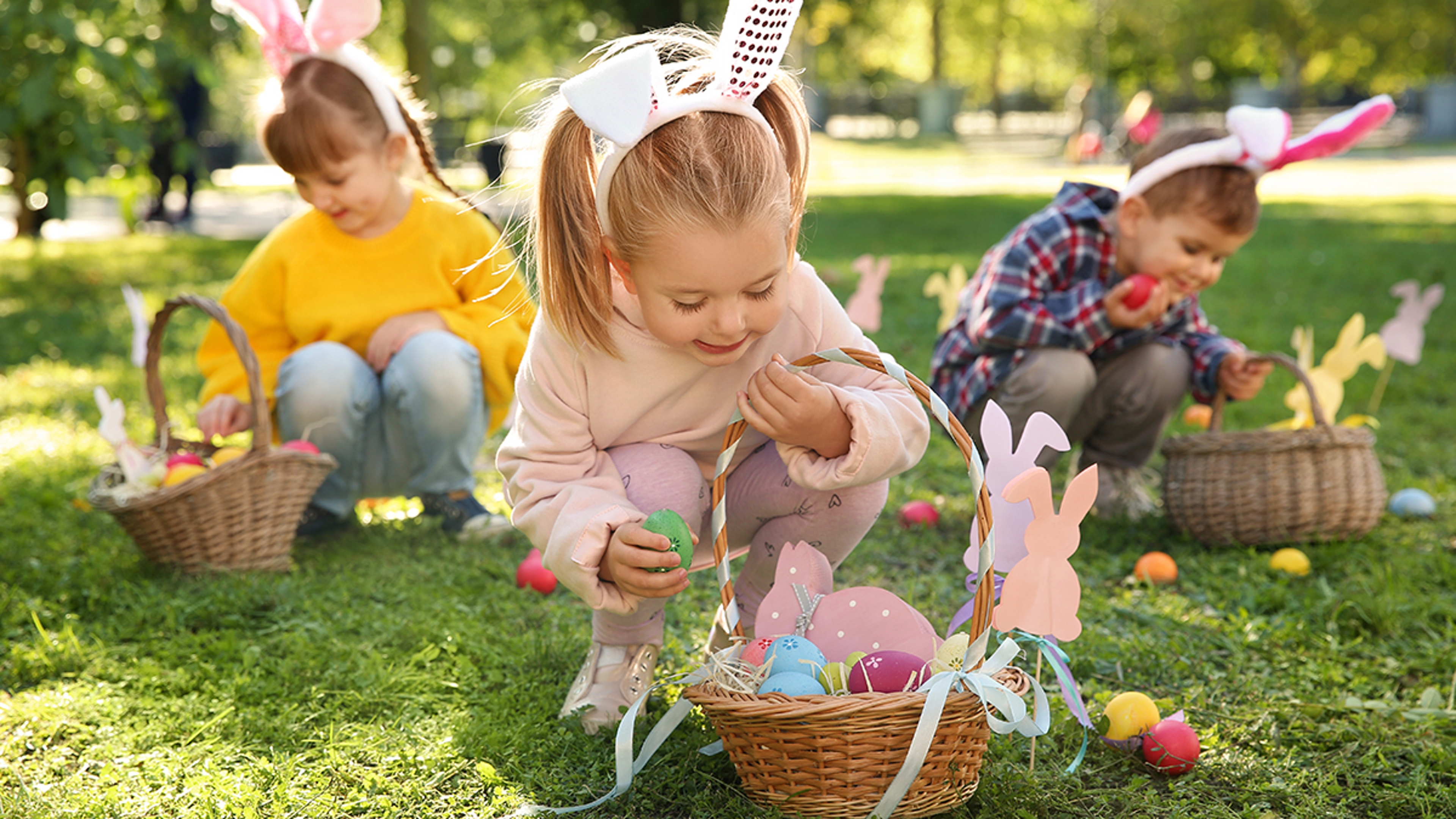 Article Cards Featured Image Cute little children hunting eggs in park. Easter tradition