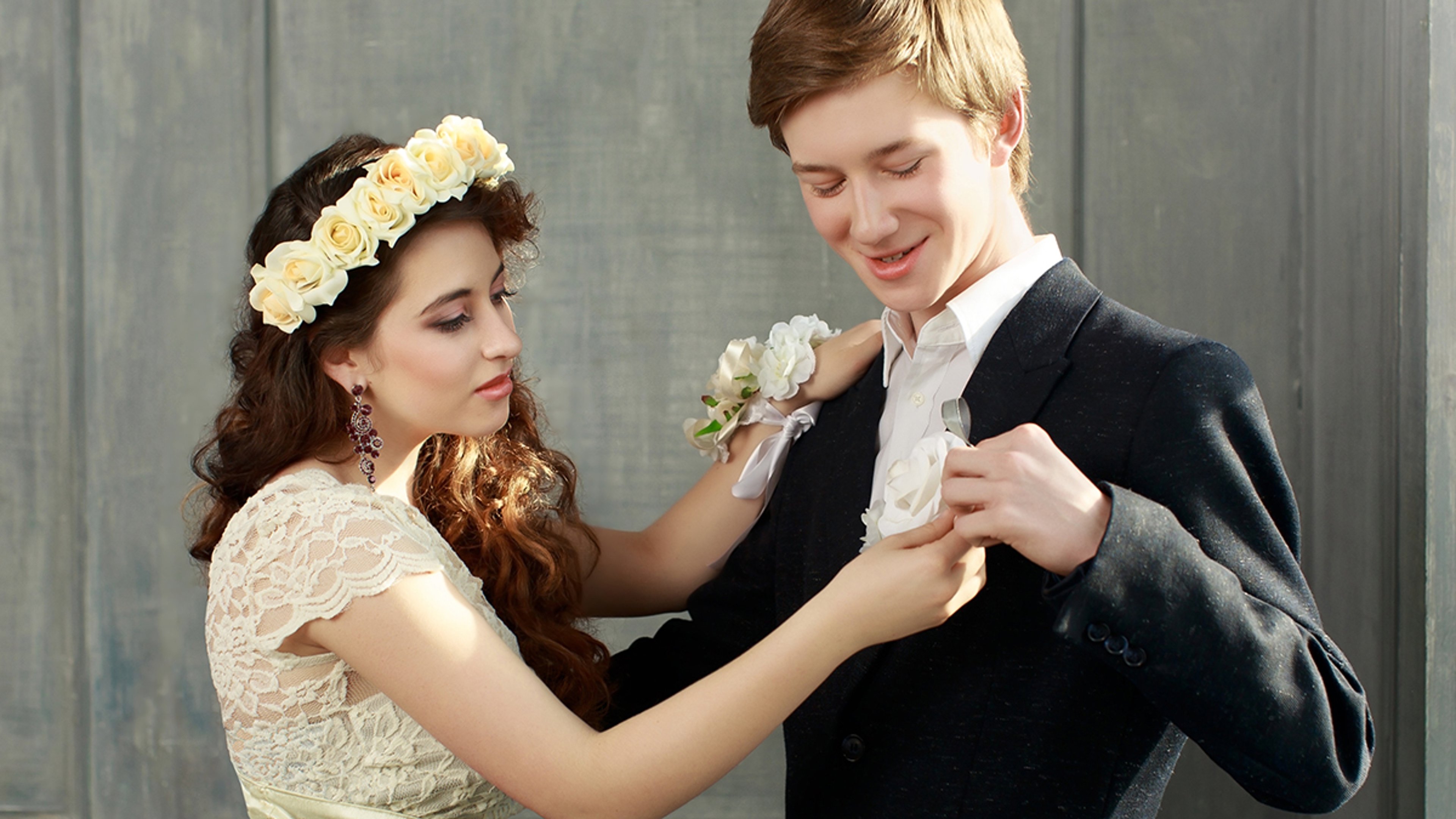 Prom date arranging corsage and boutonniere.