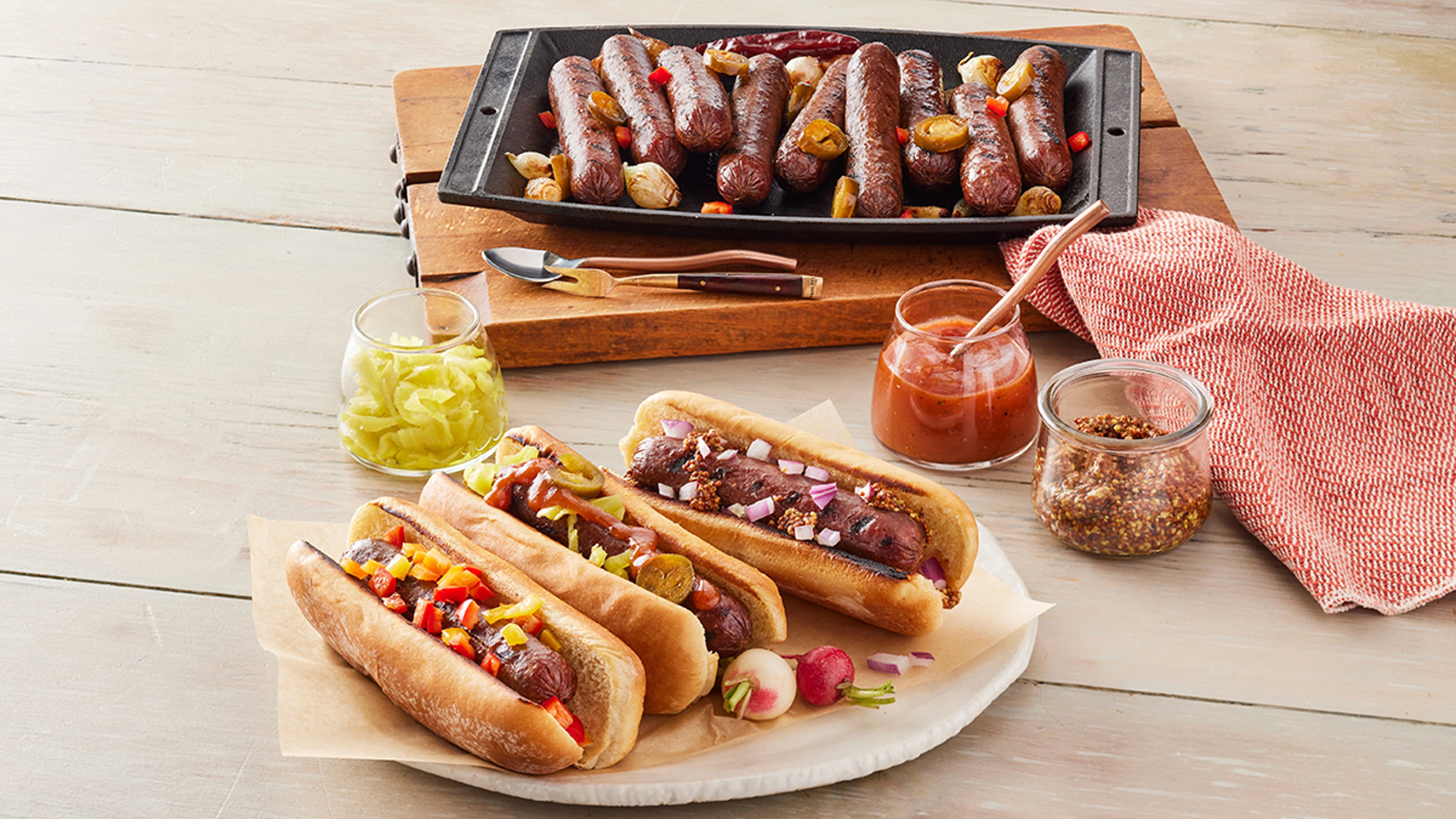 Bison recipes with a platter of hot dogs and a plate of hot dogs in buns.