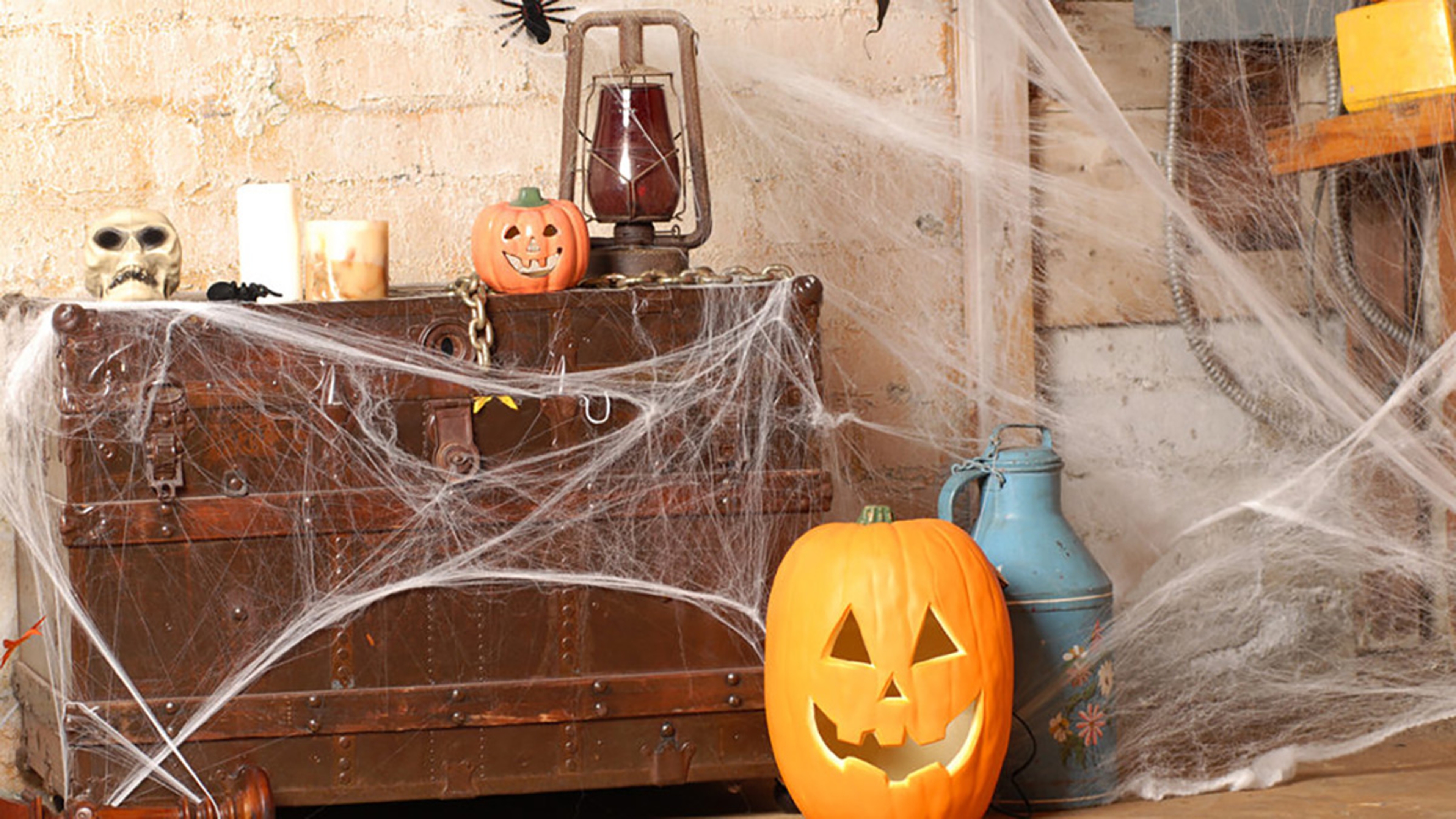 Kid friendly Halloween decorations with pumpkins and spiderwebs.