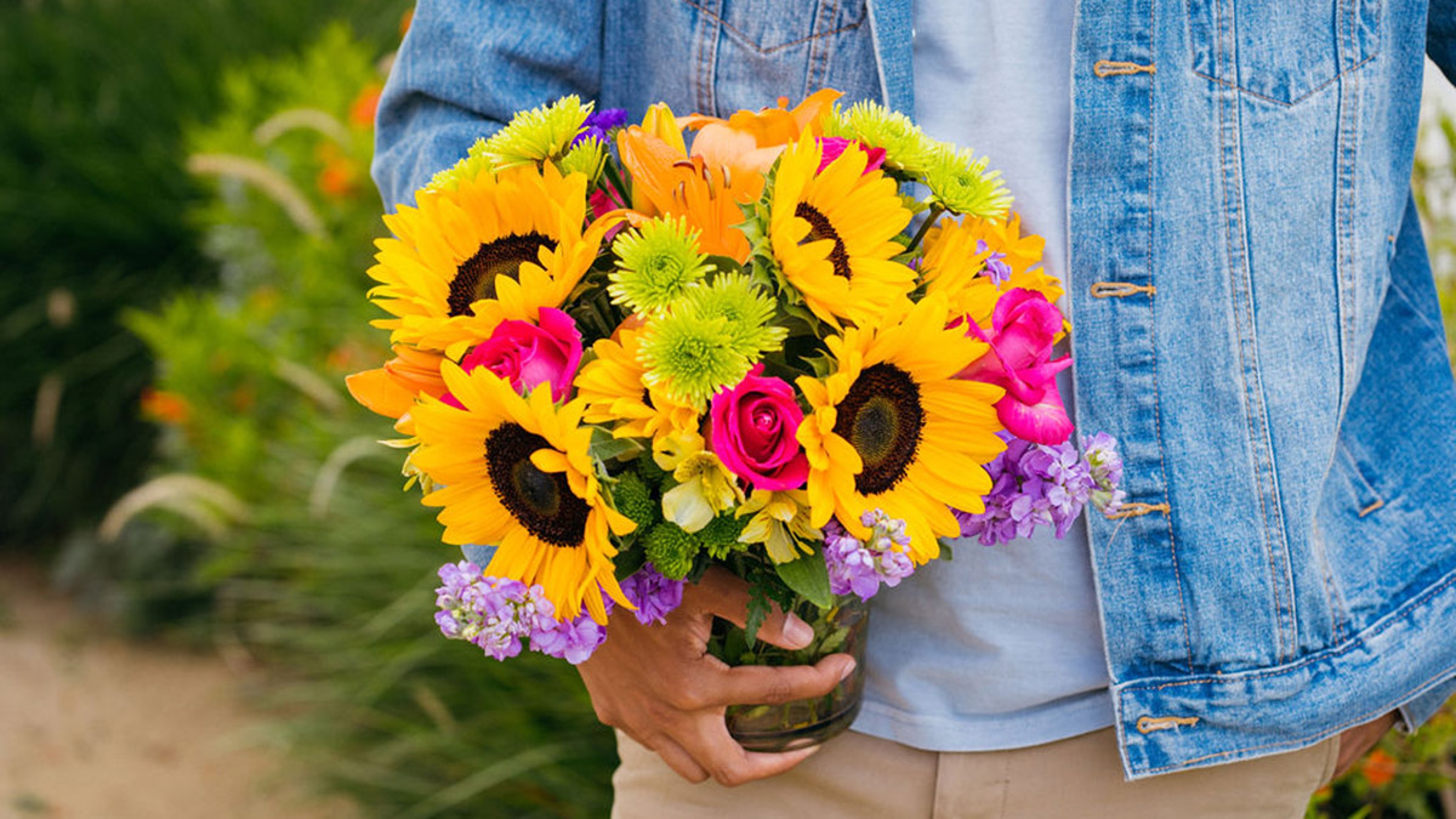 floral trends with man holding brightly colored flowers
