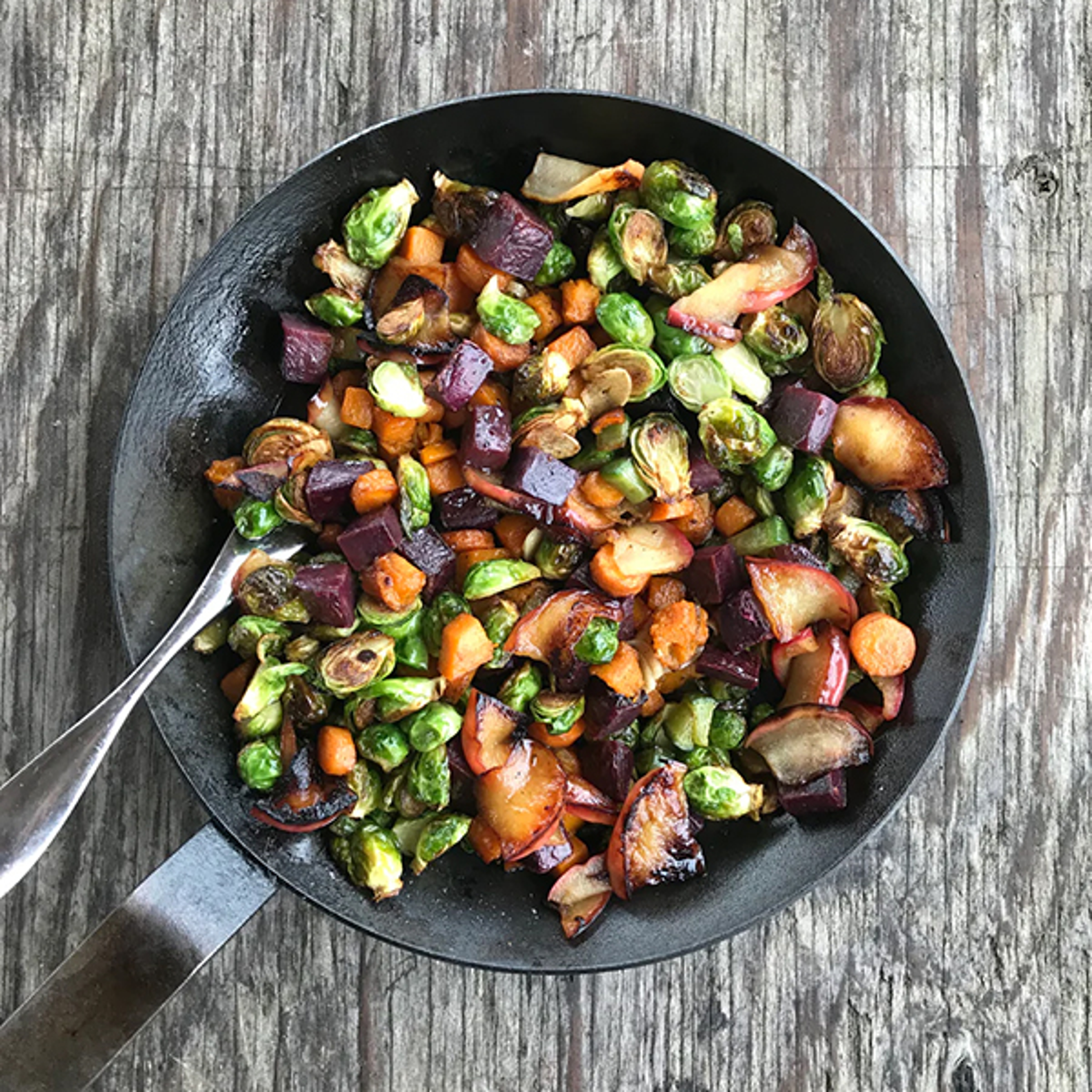 Frying pan of sweet potato and vegetable hash.