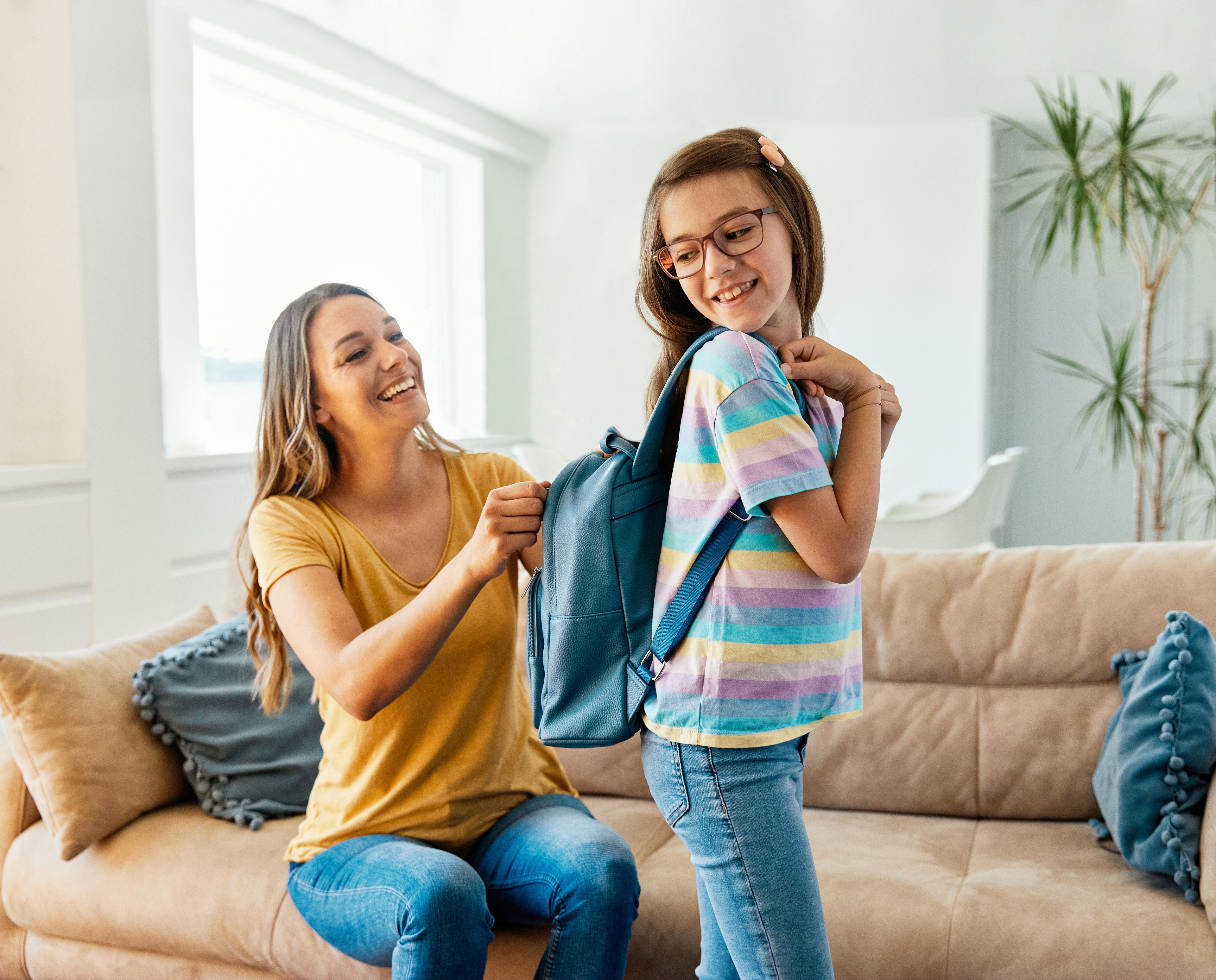 back to school rituals mom packing daugthers backpack