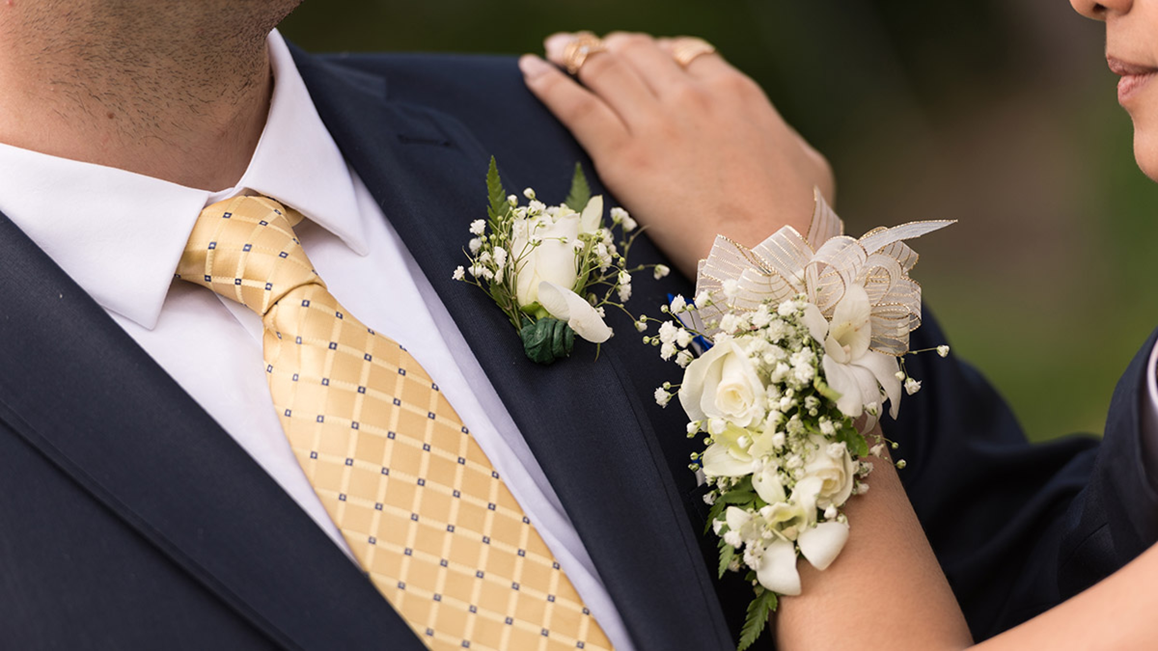 Article Cards Featured Image A prom couple showing showing both corsage.