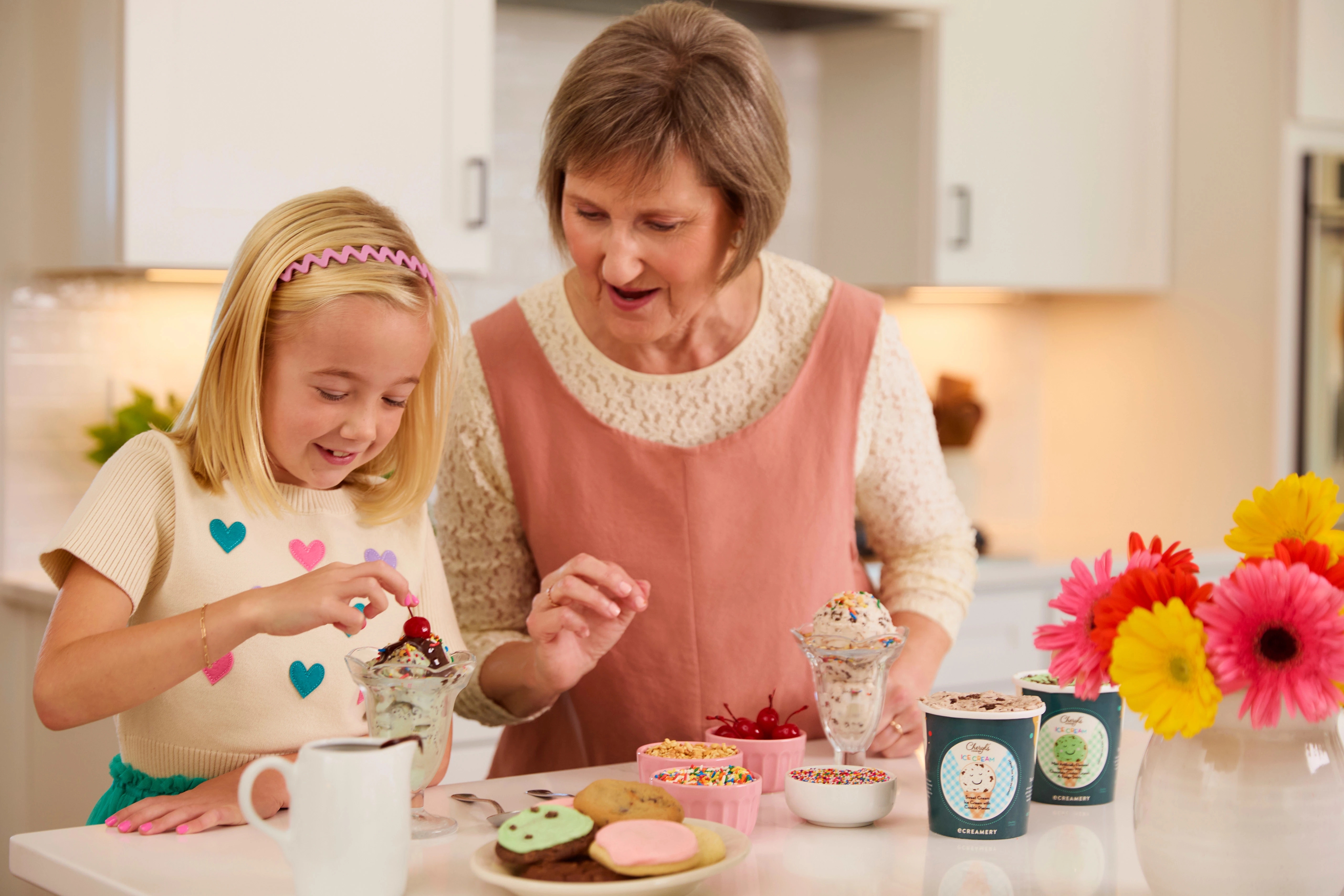 first day of summer grandma granddaughter making ice cream sundaes