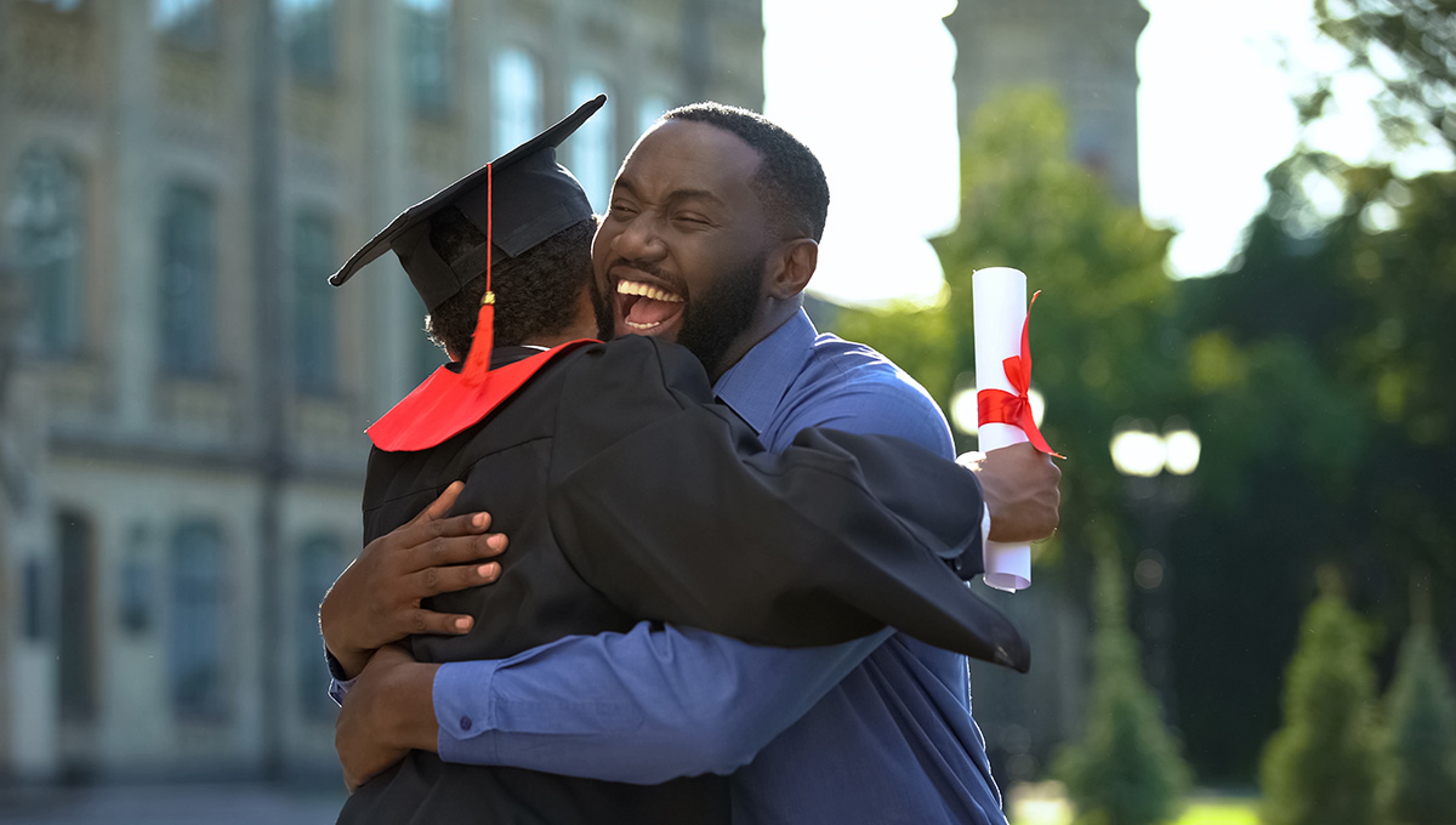 Article Cards Featured Image Cheerful father and graduating son hugging outdoor, study achiev